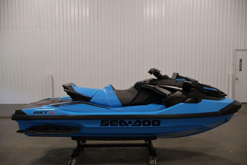 2026 Sea-Doo RXT-X 325 jet ski in vibrant blue, displayed indoors.