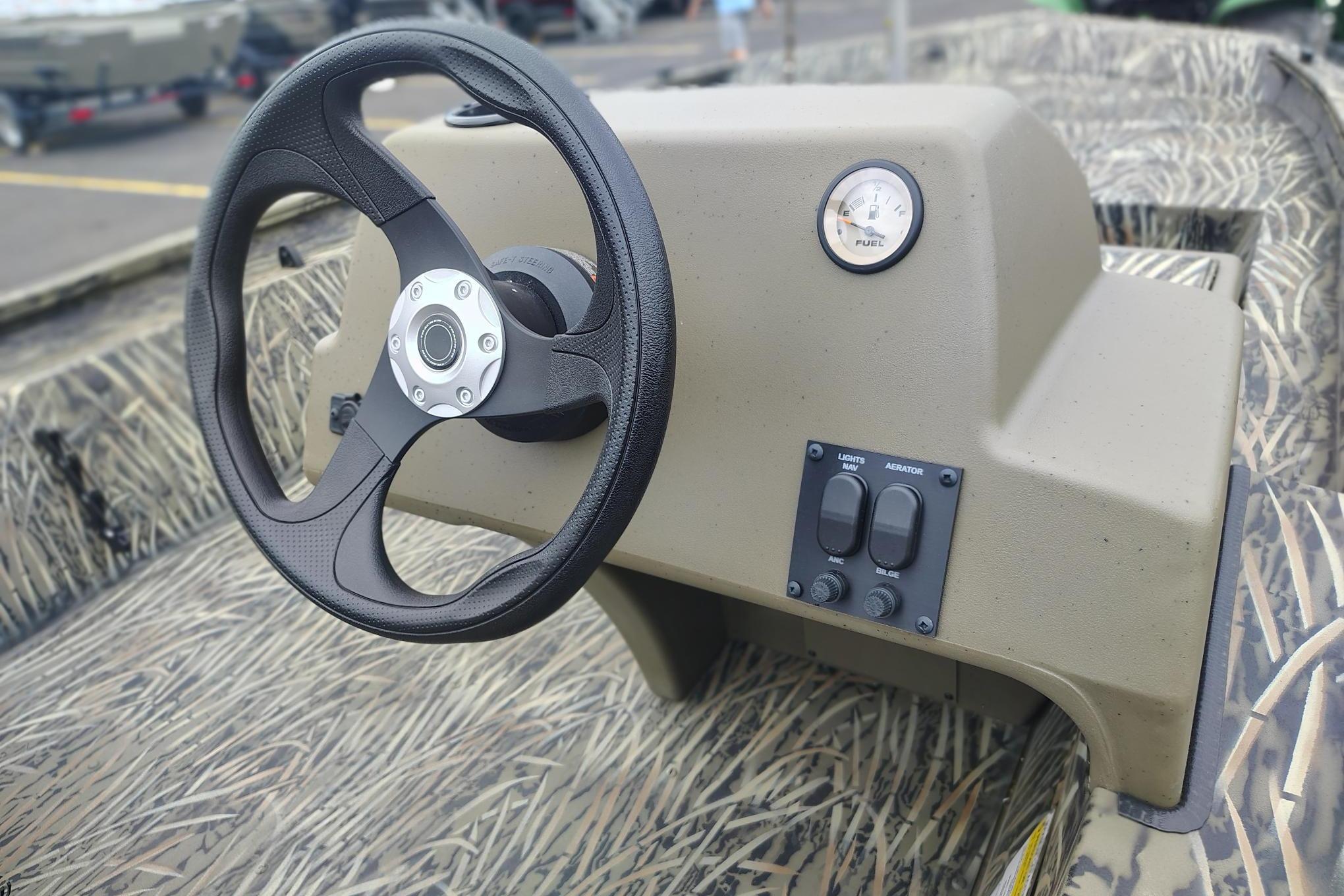 Steering console of 2026 Tracker Grizzly 1754 SC boat with camo pattern interior.