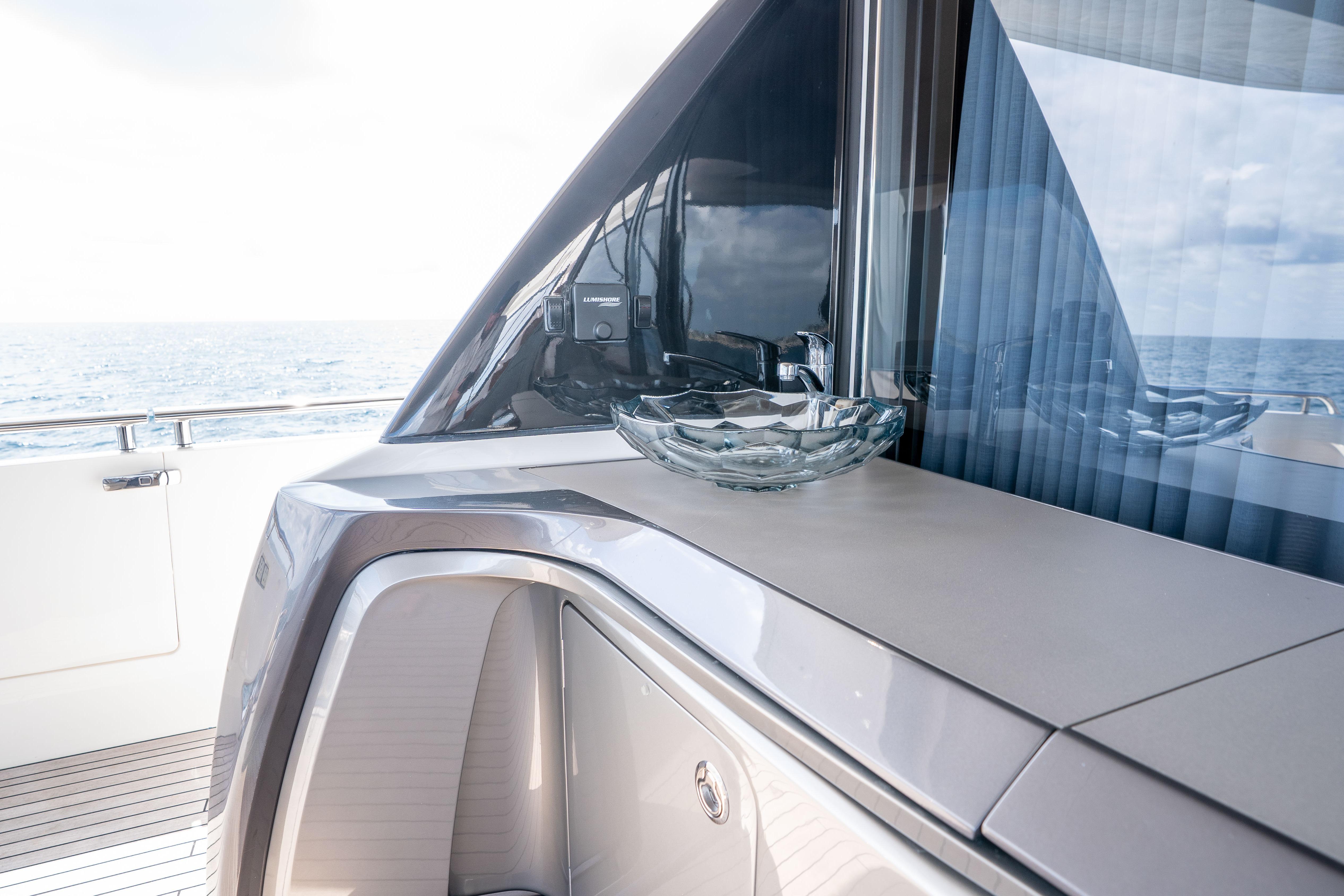 Luxurious 2020 Princess Y85 yacht deck with elegant glass bowl and ocean view.