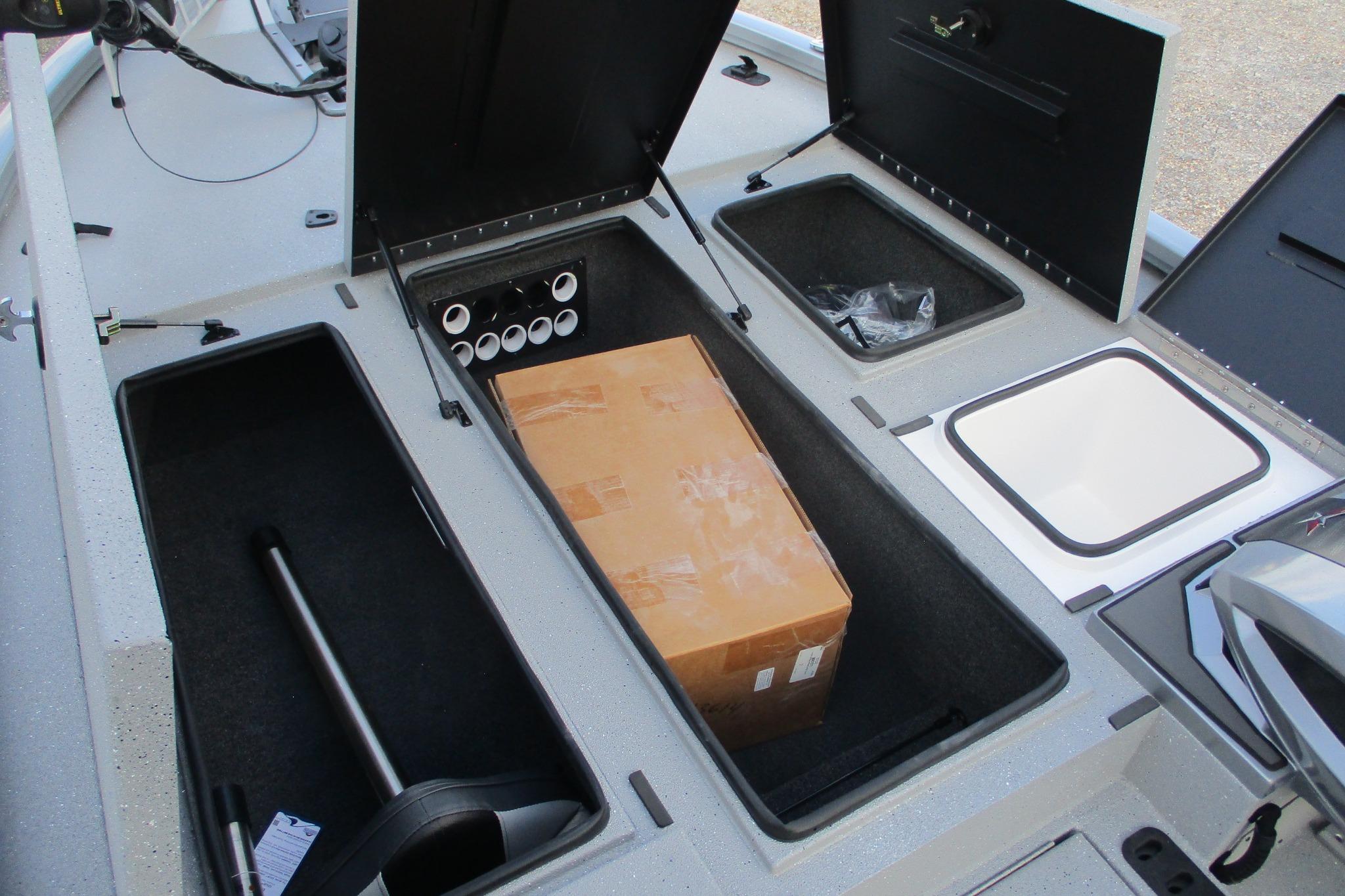 2026 Vexus AVX2080 boat storage compartments with cardboard box and equipment.