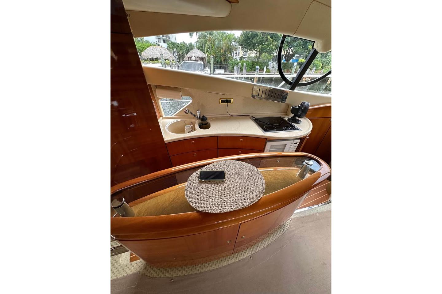 Interior of 2004 Azimut 55E yacht featuring a compact kitchen area with modern amenities.