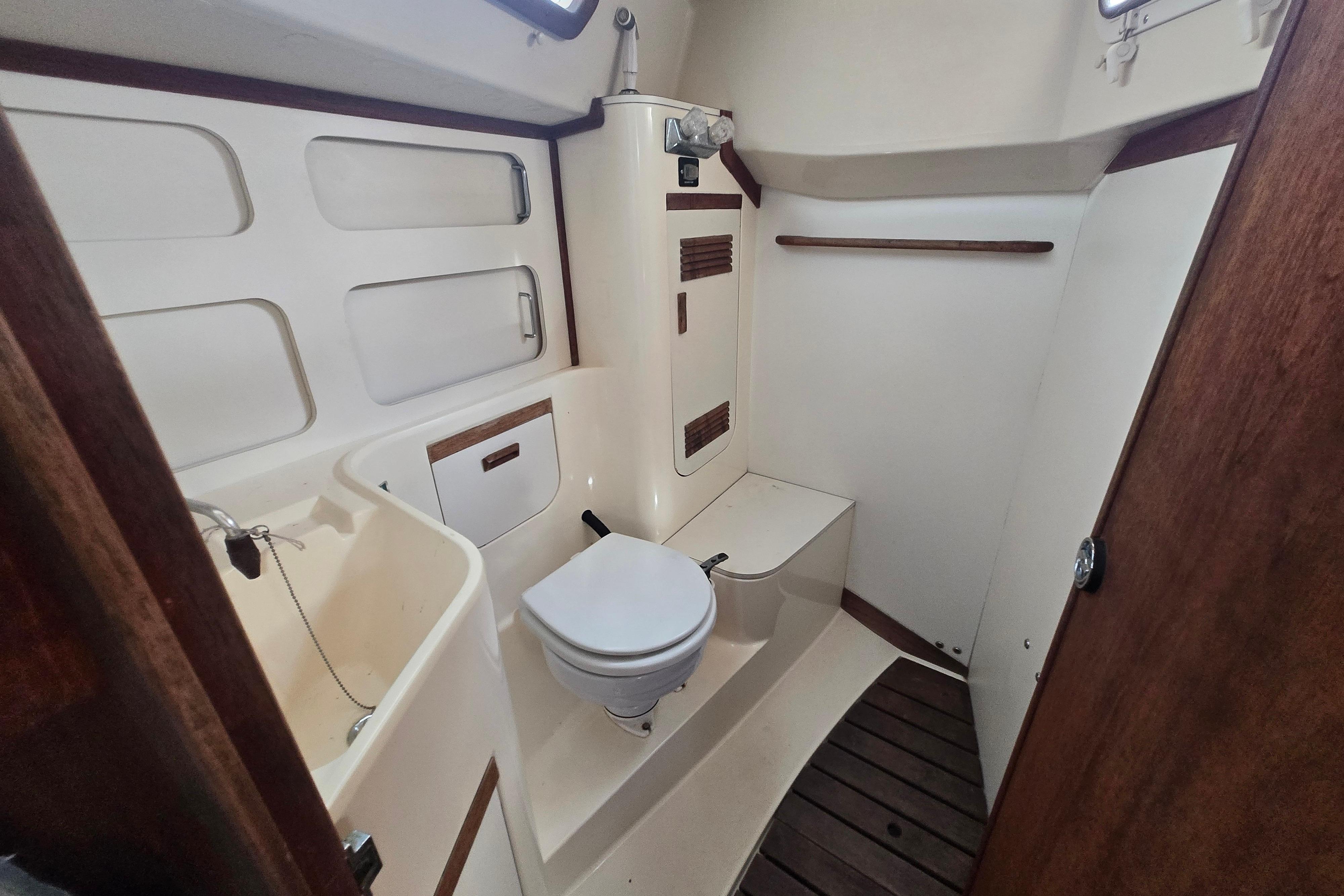 Interior of 1988 Sabre 38 sailboat bathroom with toilet and sink.