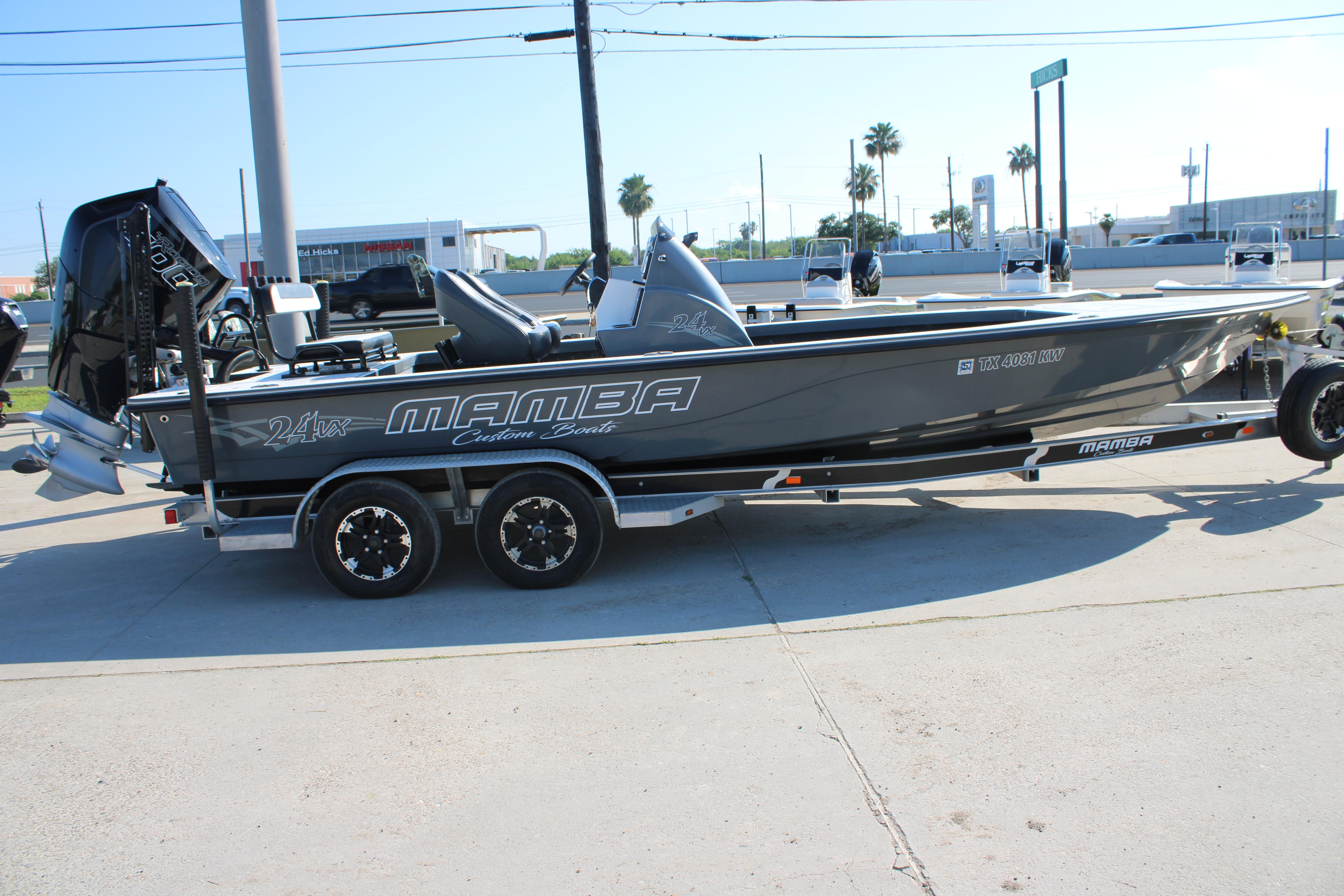 2023 Mamba 24VX boat on trailer, sleek design, parked outdoors.