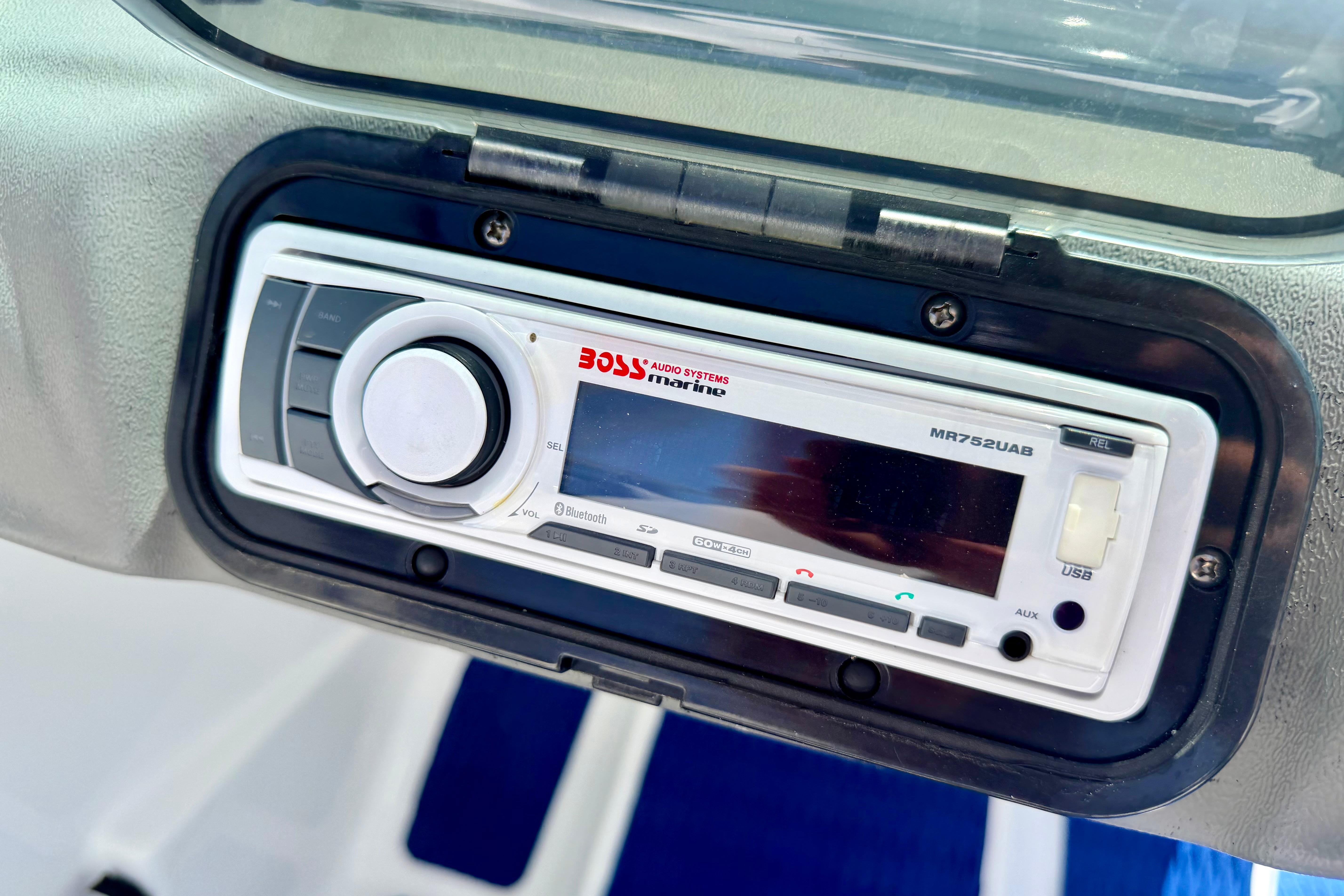 Marine stereo system on a 2004 Bombardier SEADOO Utopia 185 boat dashboard.