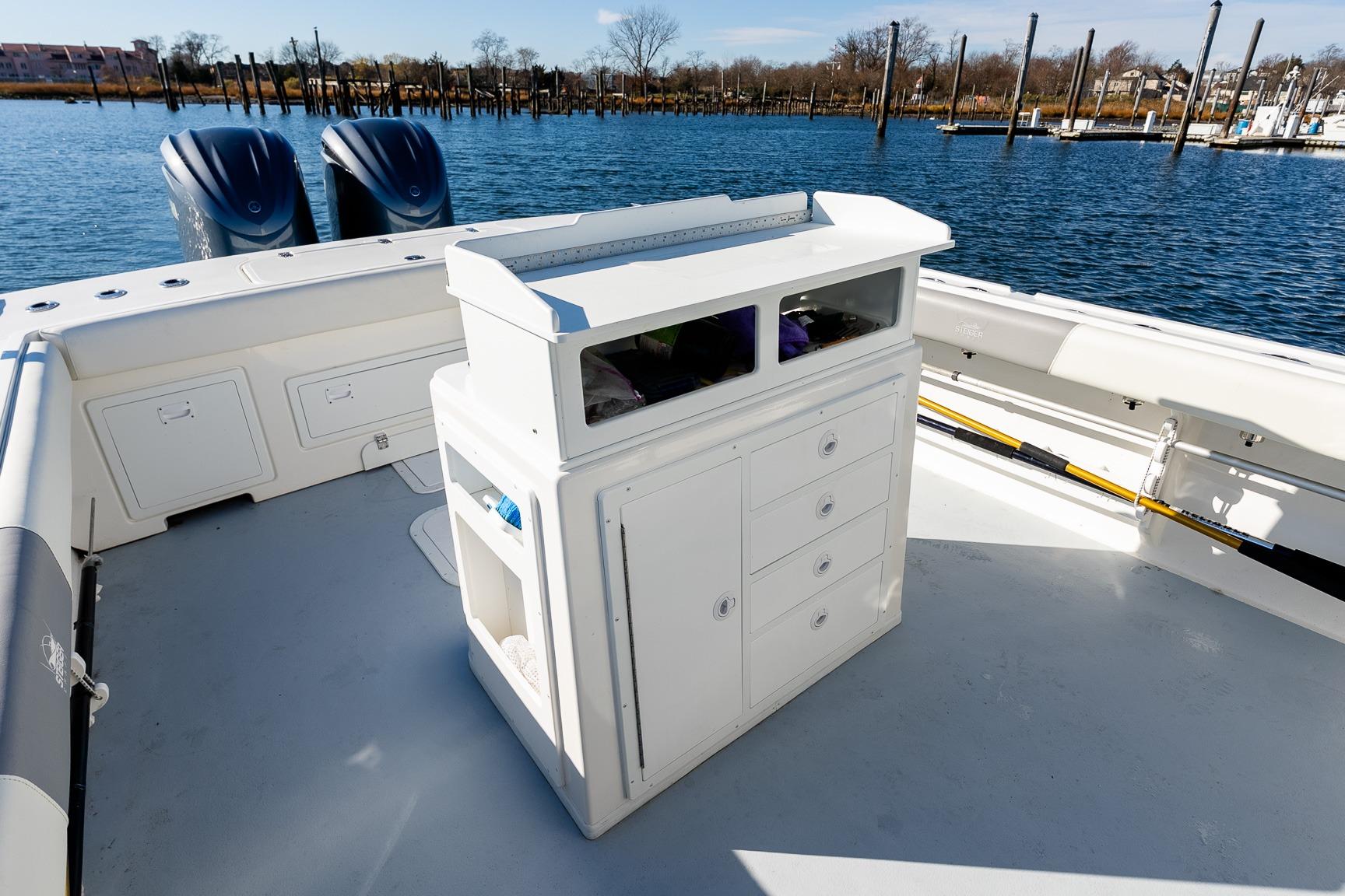 2024 Steiger Craft 31 Fisherman boat interior with storage and dual engines on a calm water backdrop.