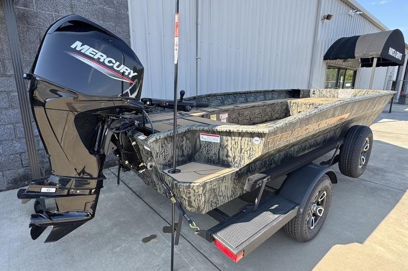 2026 Tracker Grizzly 1756 T Marsh boat with Mercury engine, parked on trailer.