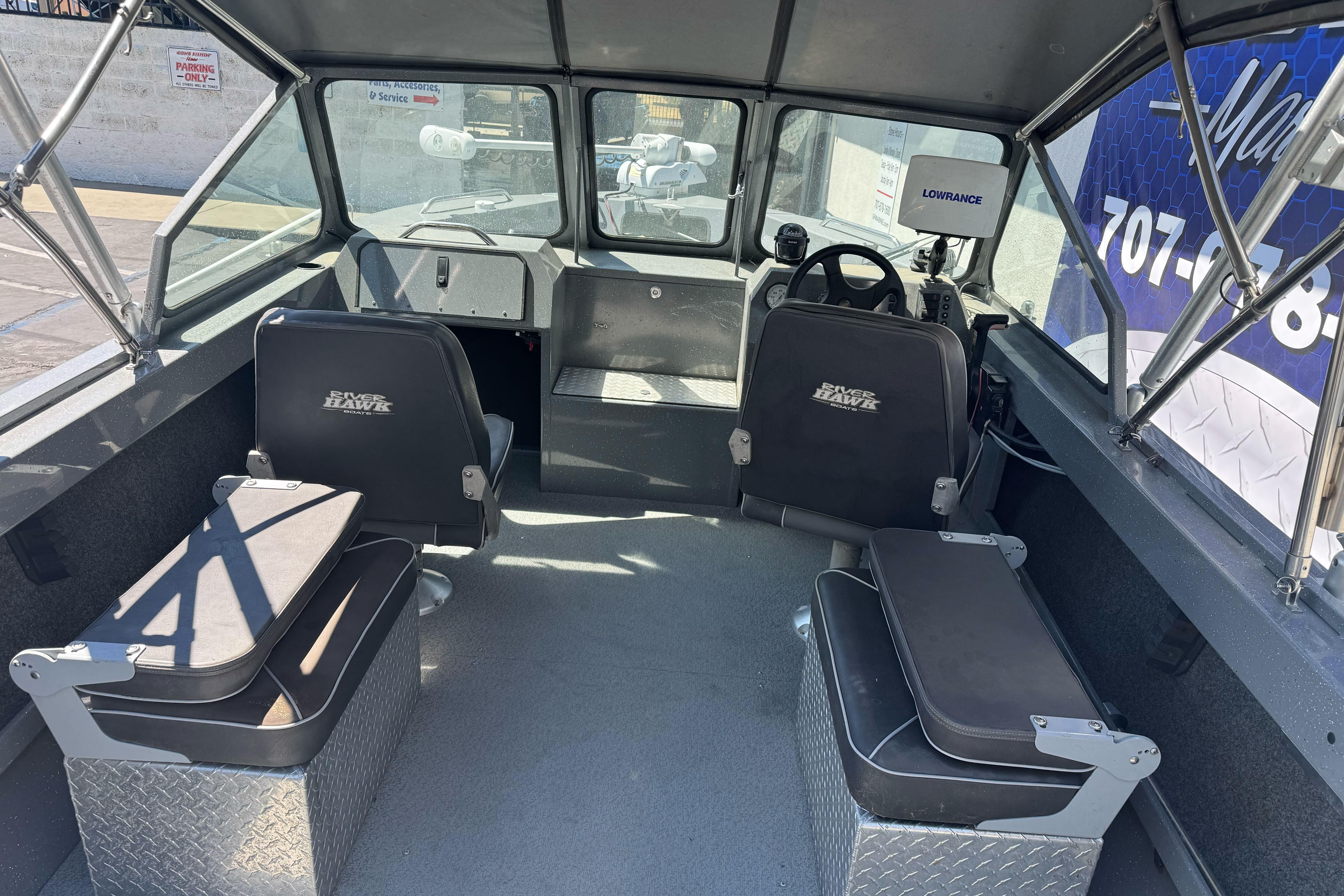 Interior of a 2014 River Hawk 19 GB boat with seating and navigation equipment.