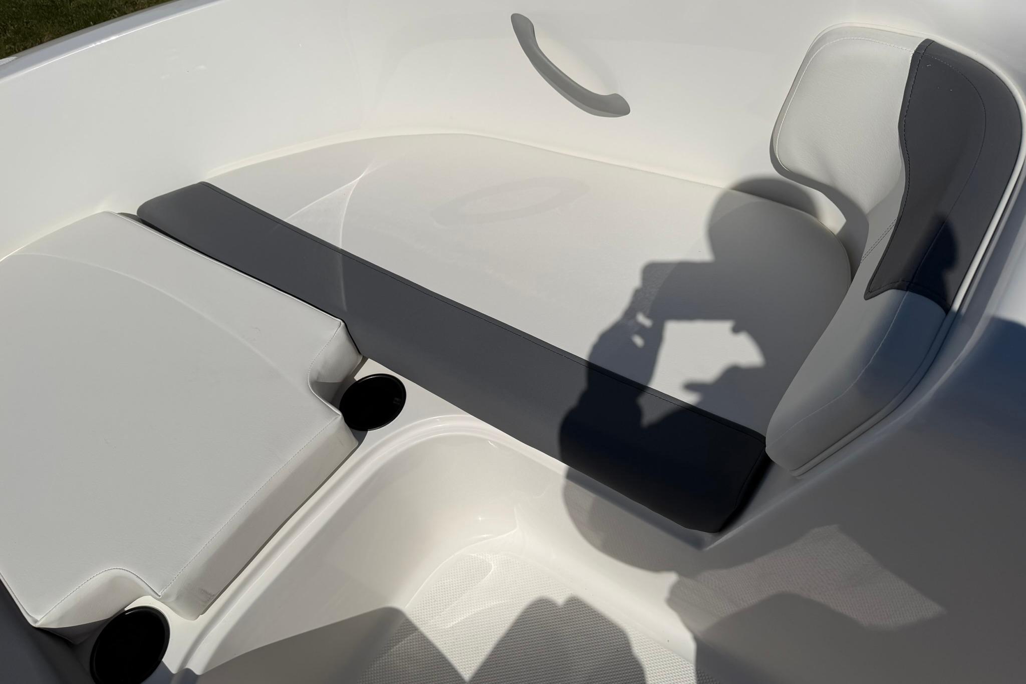 Interior seating of 2026 Bayliner Element E18 boat, featuring sleek white and gray design.