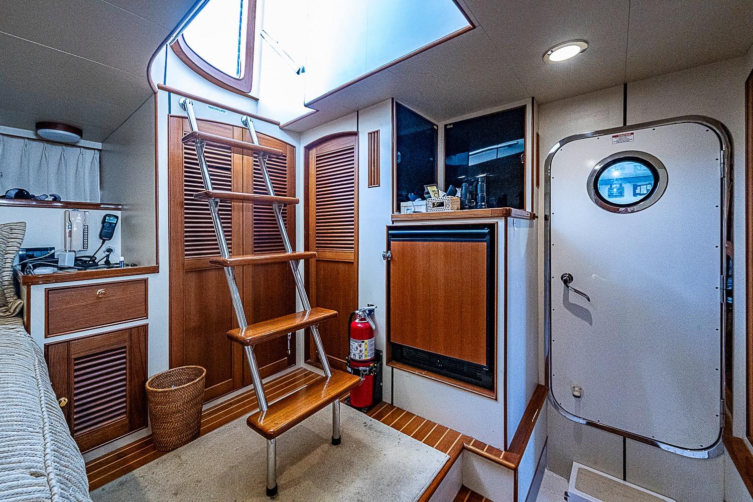 Interior of 2014 Marlow 80 Explorer yacht with wooden stairs and nautical decor.