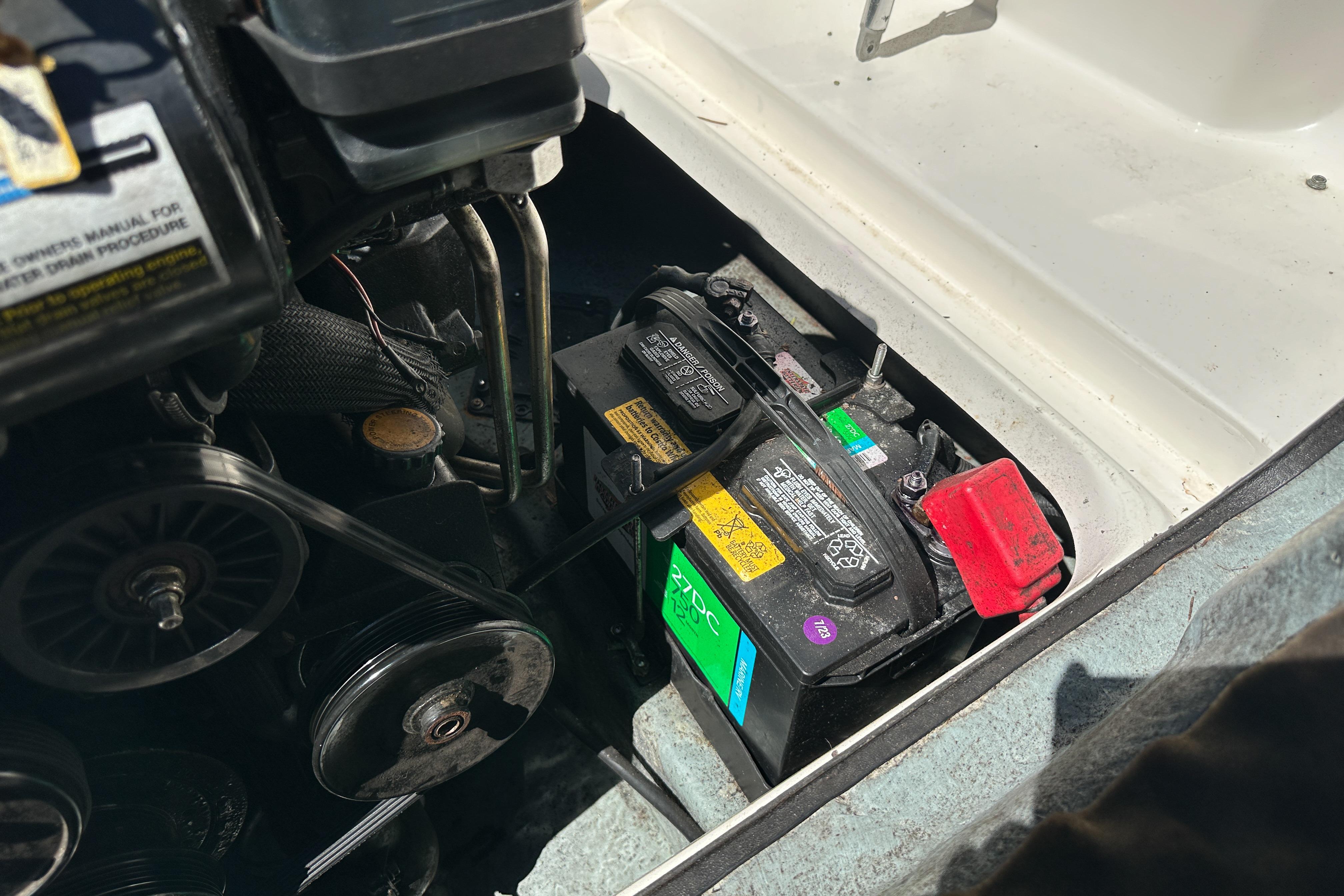 Battery compartment of a 1998 Sea Ray 215 Express Cruiser boat engine.