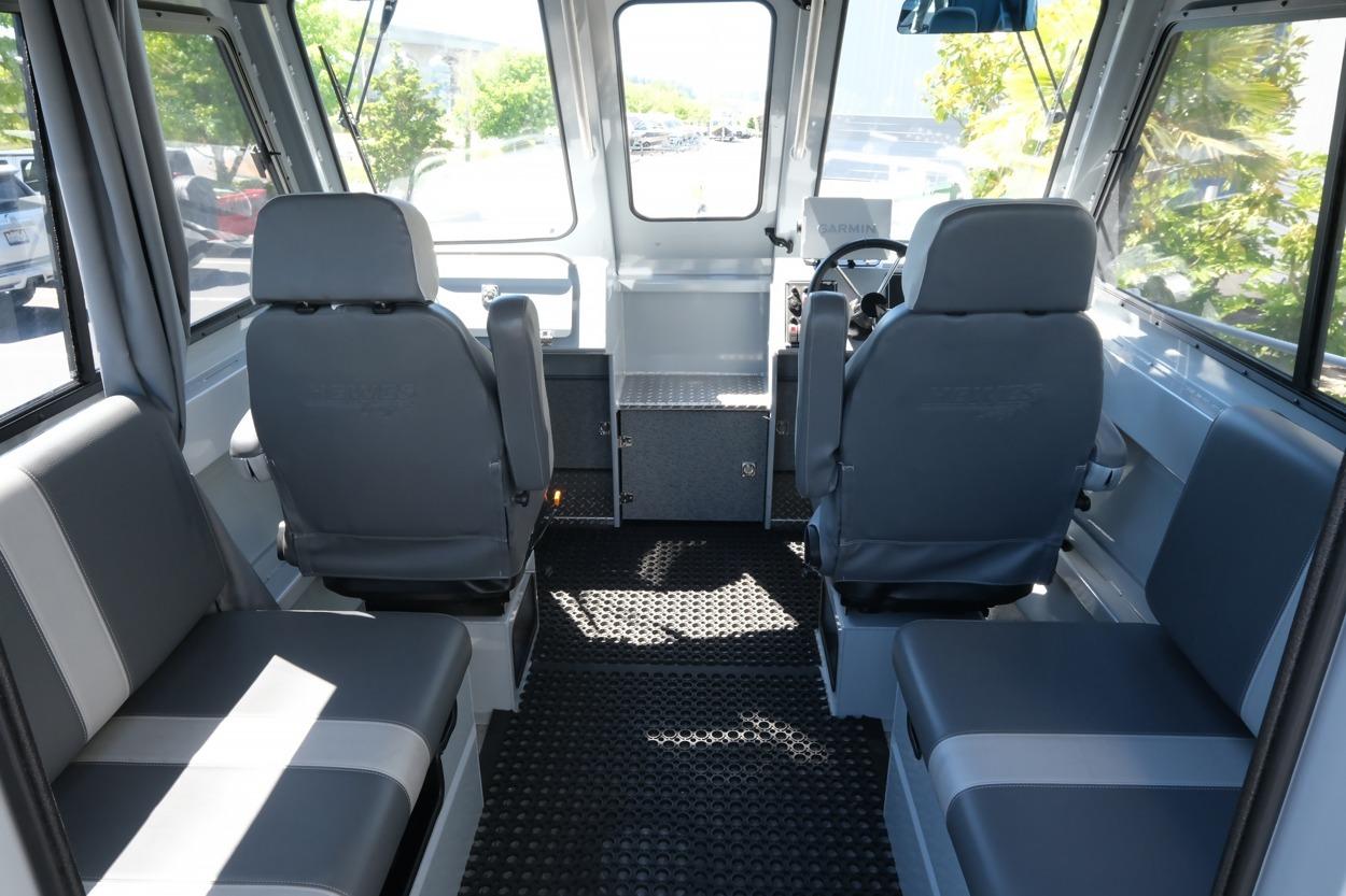 Interior of 2018 Hewescraft 220 Ocean Pro ET Hardtop, featuring seating and helm.