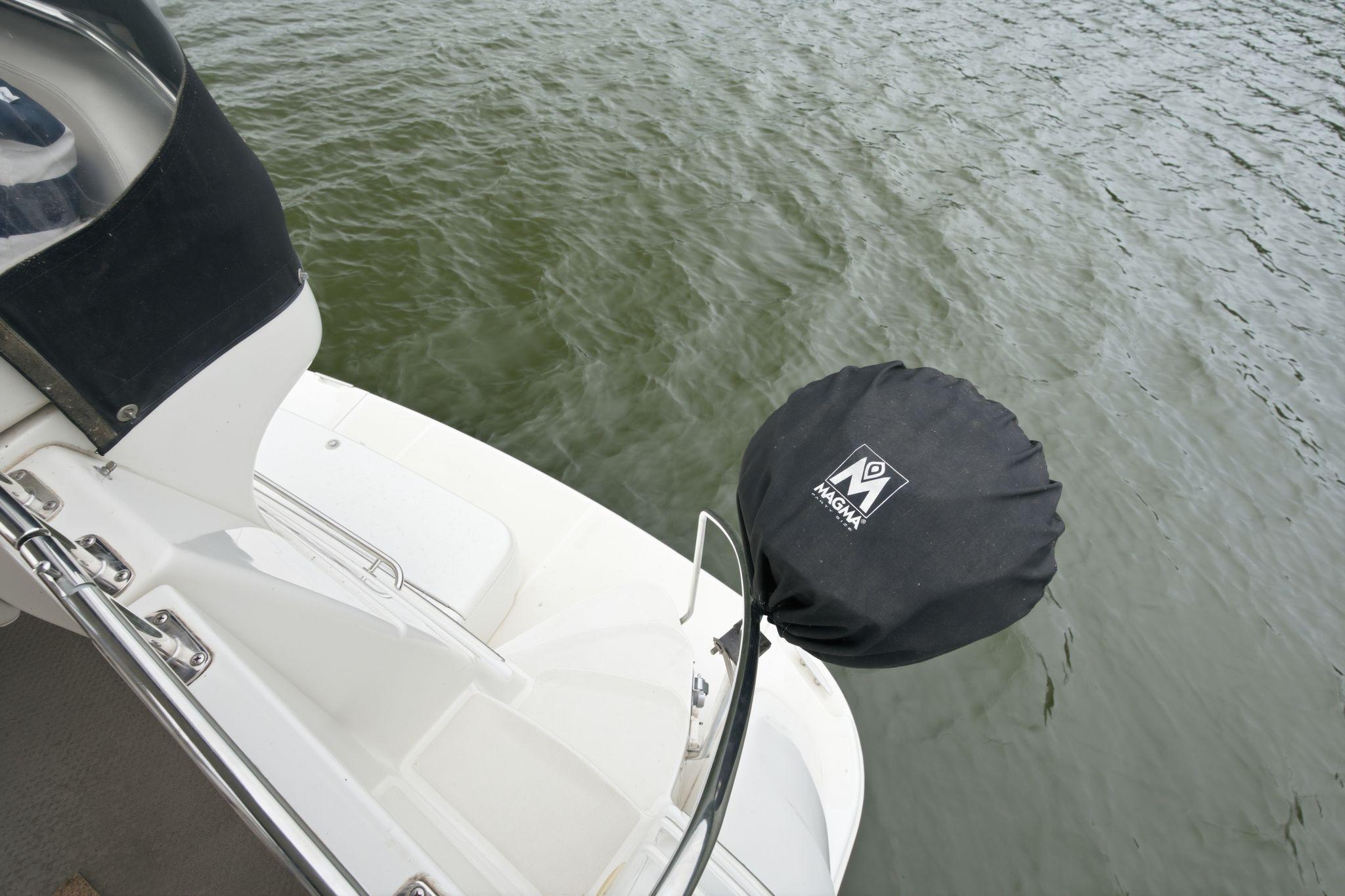 2005 Carver 39 Motor Yacht deck with Magma grill cover, near water.