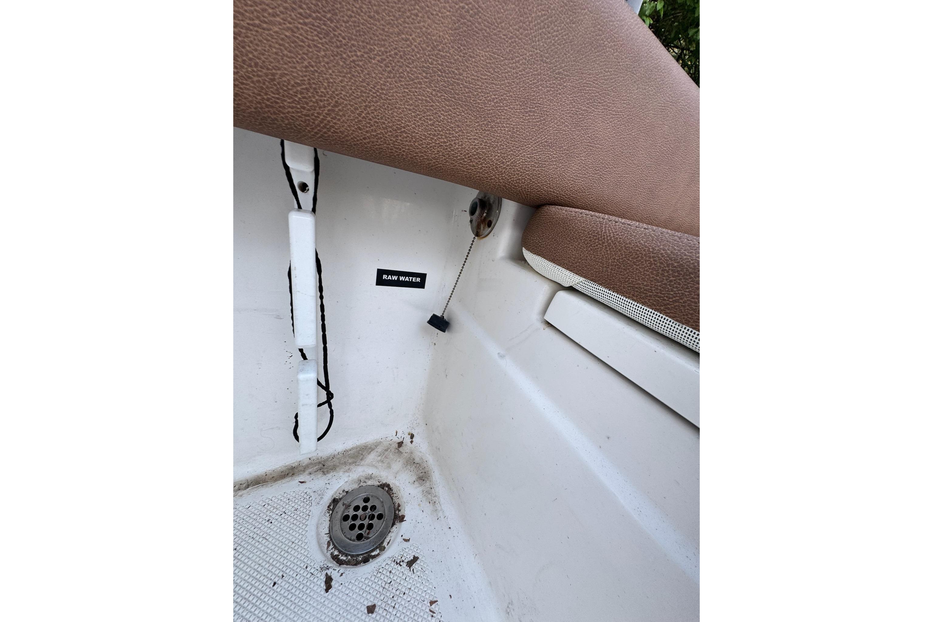Interior view of a 2013 Sea Fox 246 Commander boat, showing raw water access.