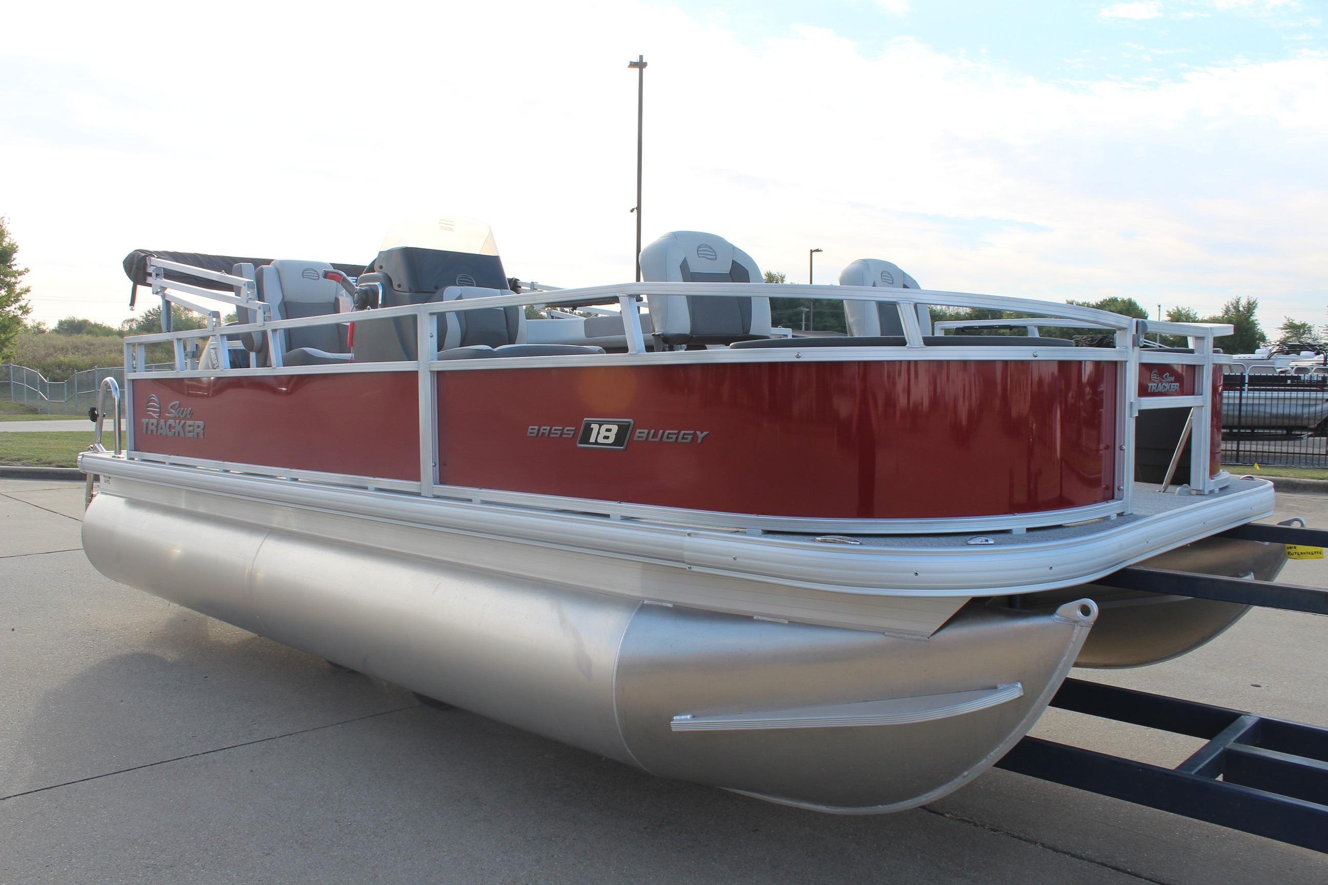 2026 Sun Tracker Bass Buggy 18 DLX pontoon boat with red exterior on a trailer.