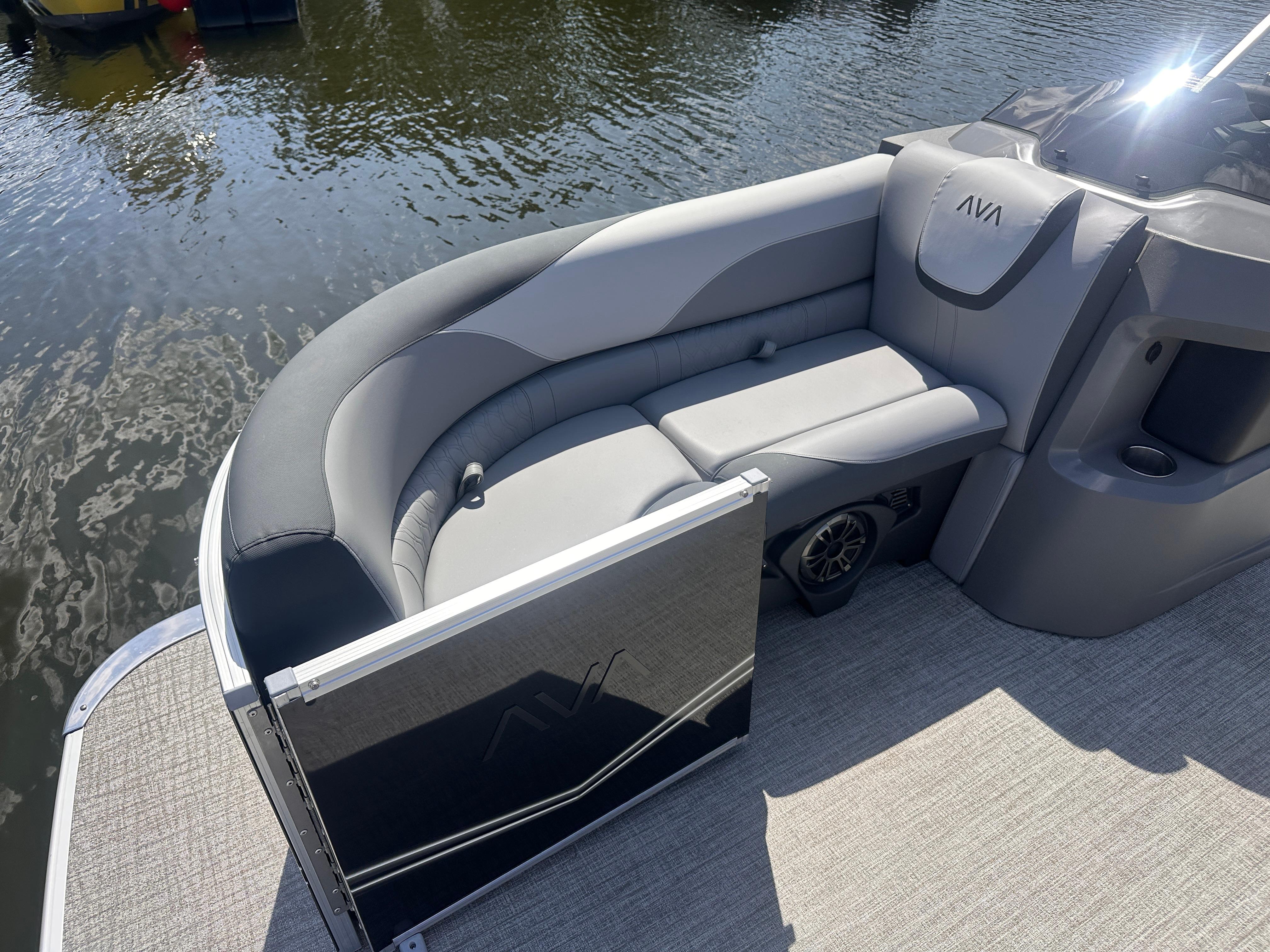2025 Avalon LSZ Quad Lounger boat interior with gray seating by the water.