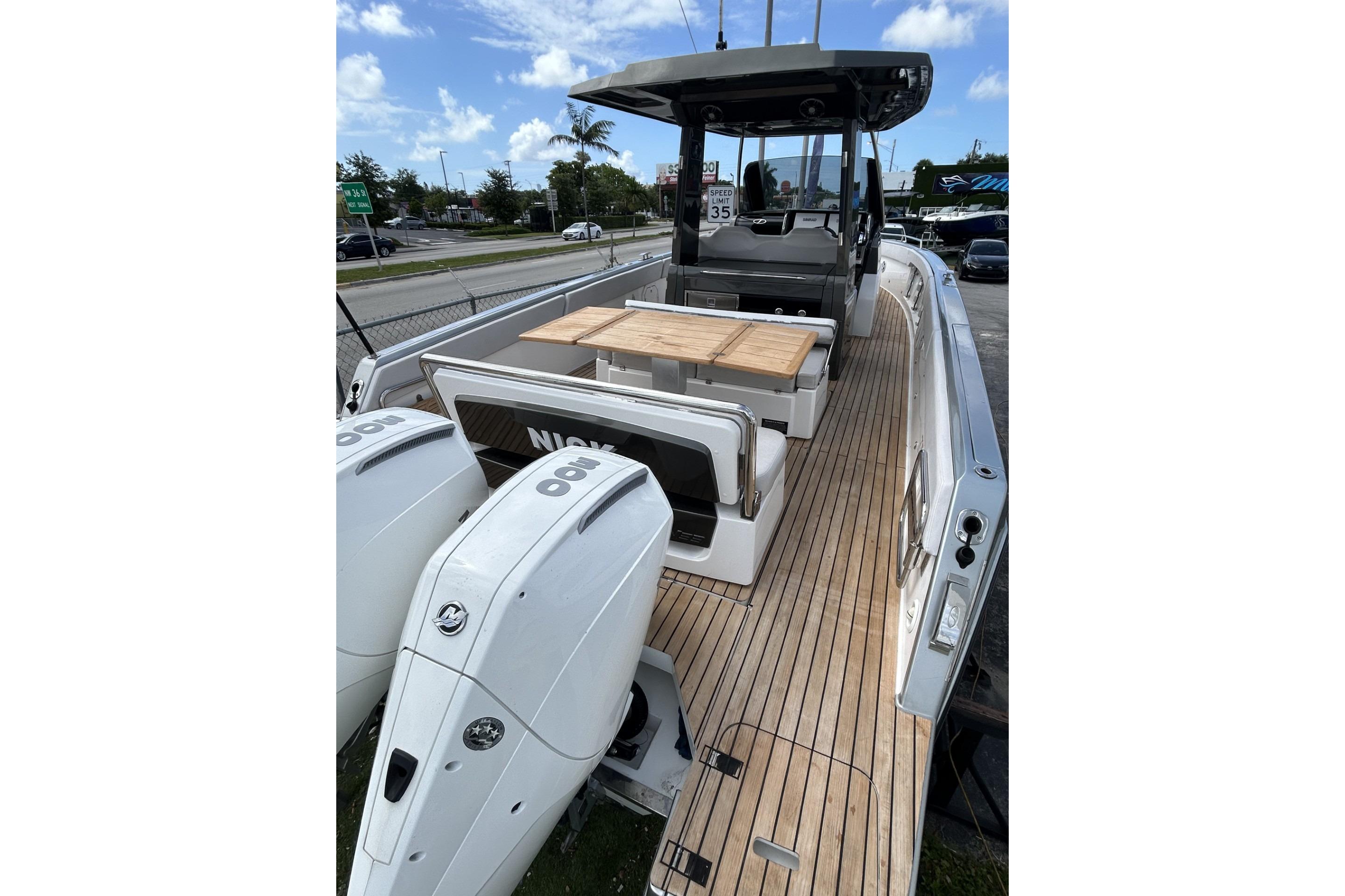 2023 Schaefer V33 boat with twin outboard engines and teak deck.