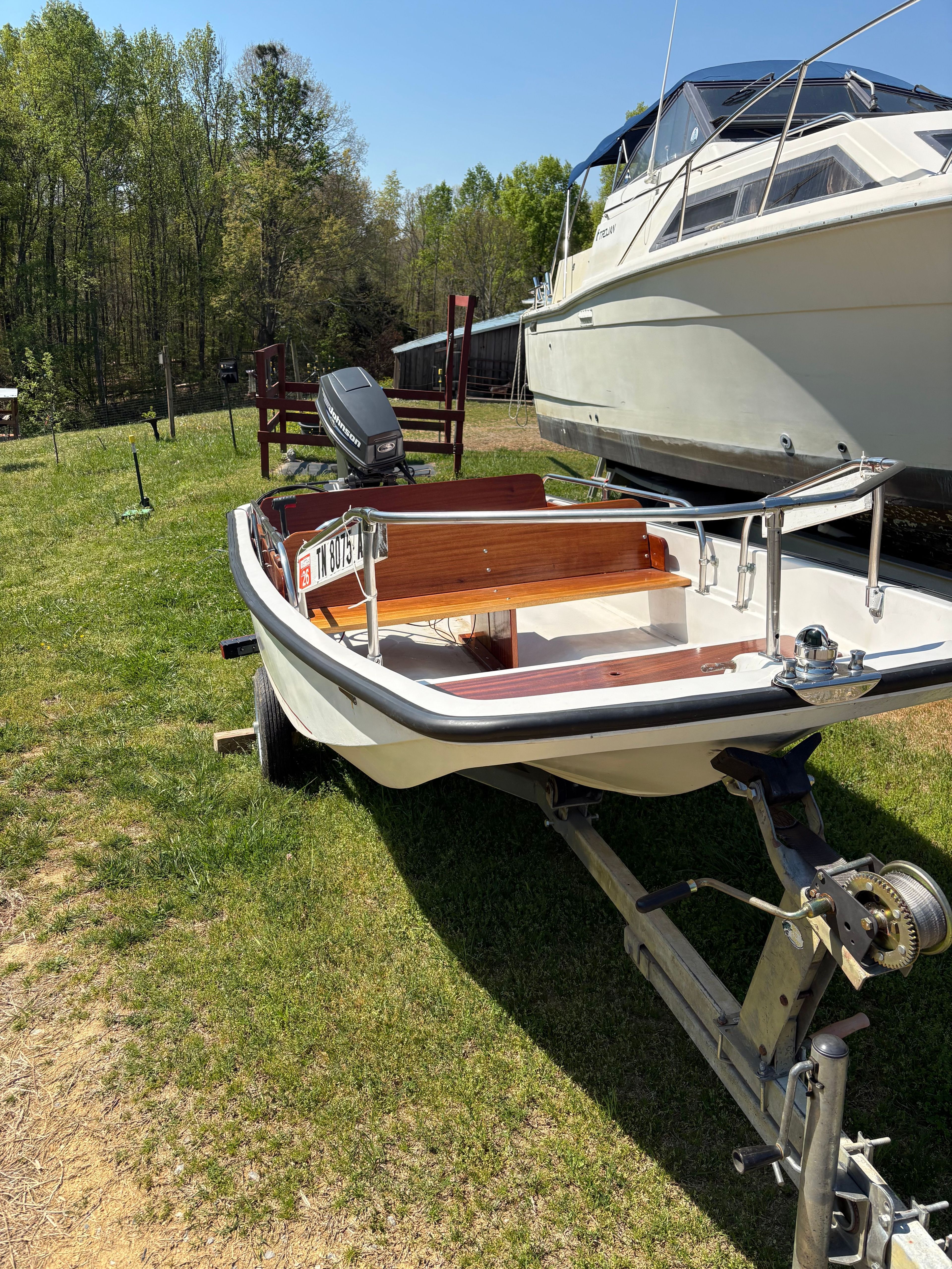 1977 Boston Whaler 13 boat on trailer parked outdoors.