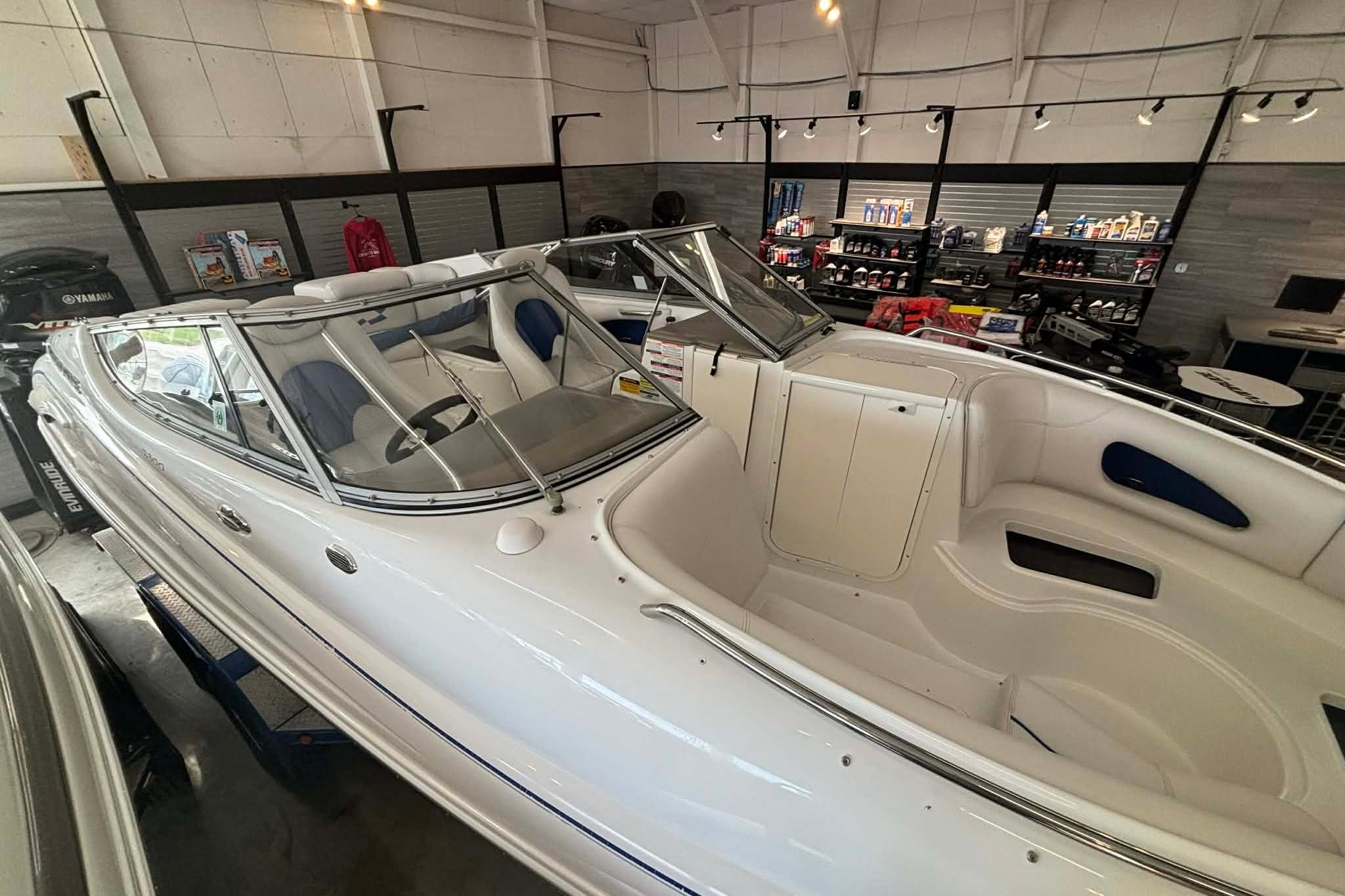 1999 Tide Craft Trophy Angler boat displayed in a showroom with accessories.