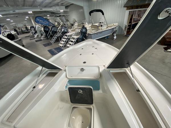 2024 Key West 250 Bay Reef boat interior, open storage compartments, showroom display.