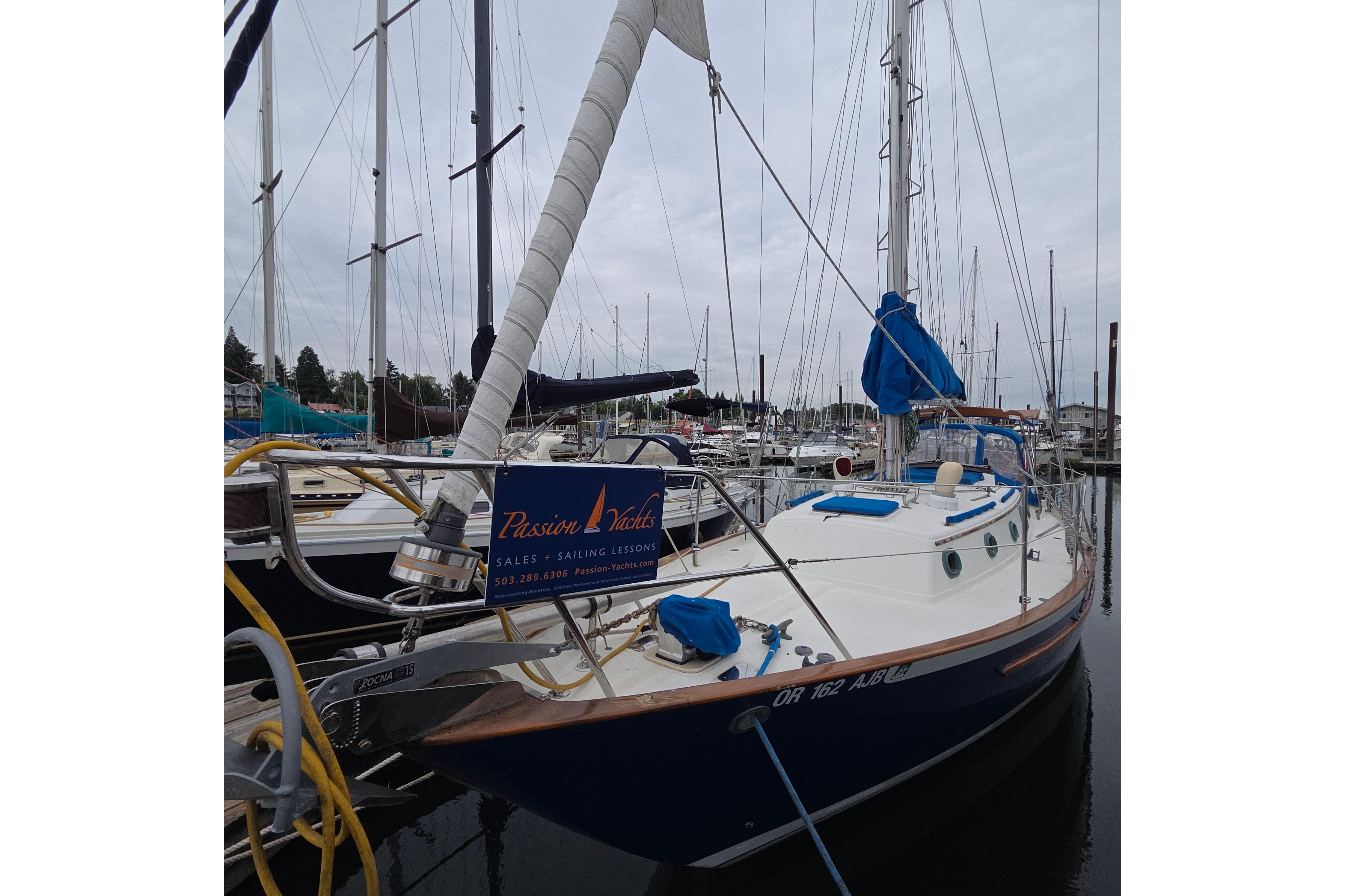 1983 Pacific Seacraft 34 sailboat docked at marina, featuring blue and white design.