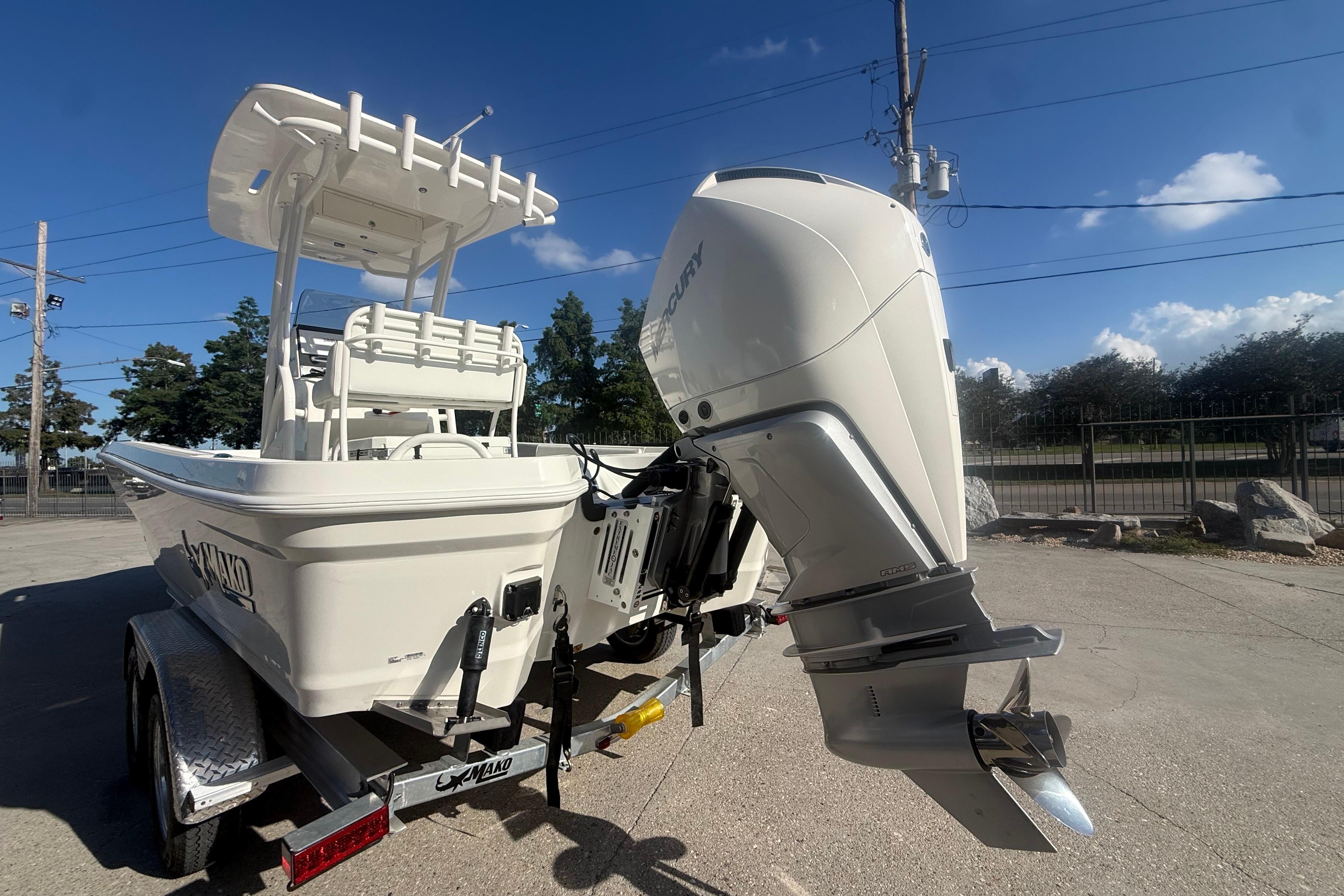 2026 Mako 24 APEX boat with powerful outboard motor on trailer.