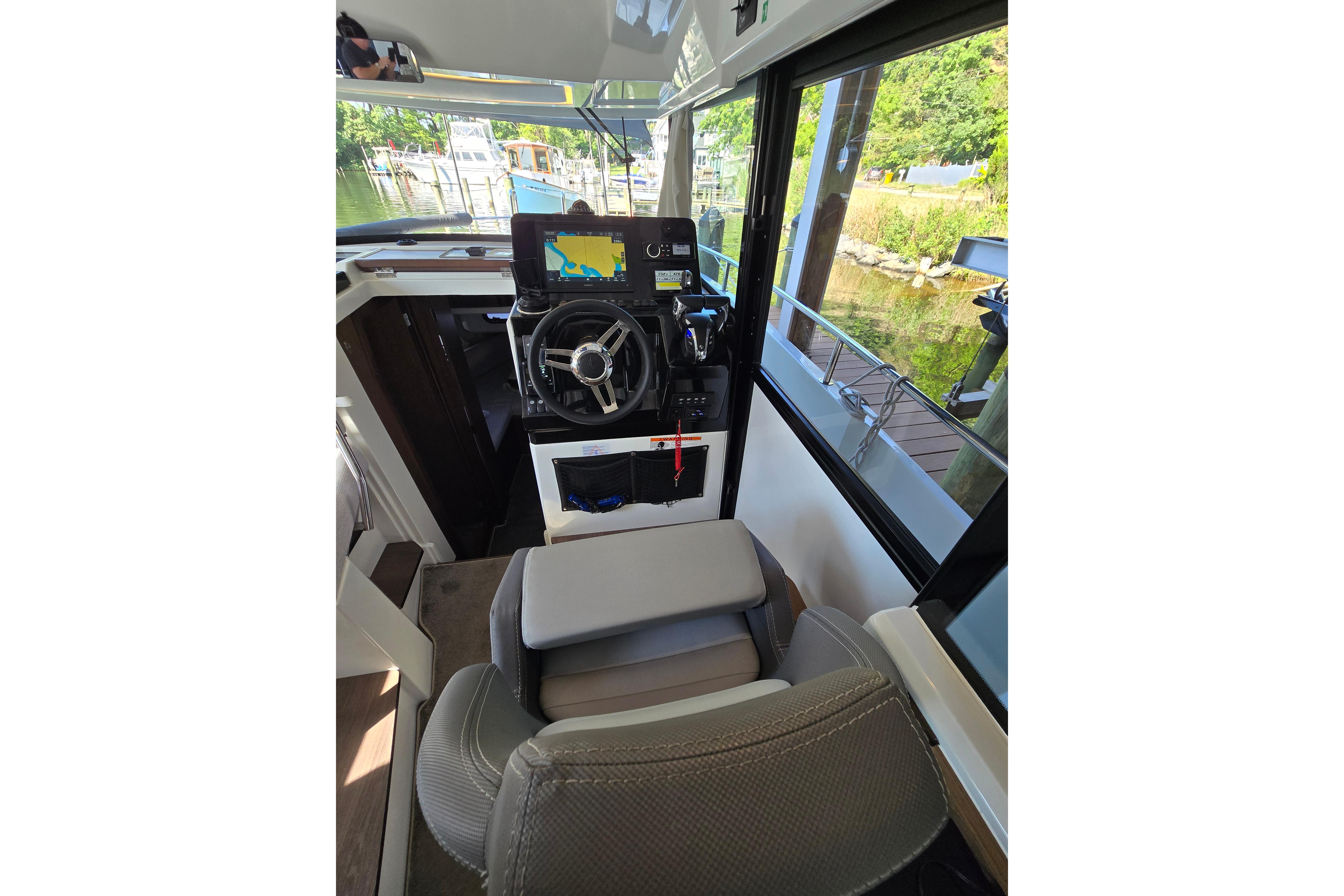 Interior view of a Jeanneau NC Sport 895 boat with helm and navigation system.