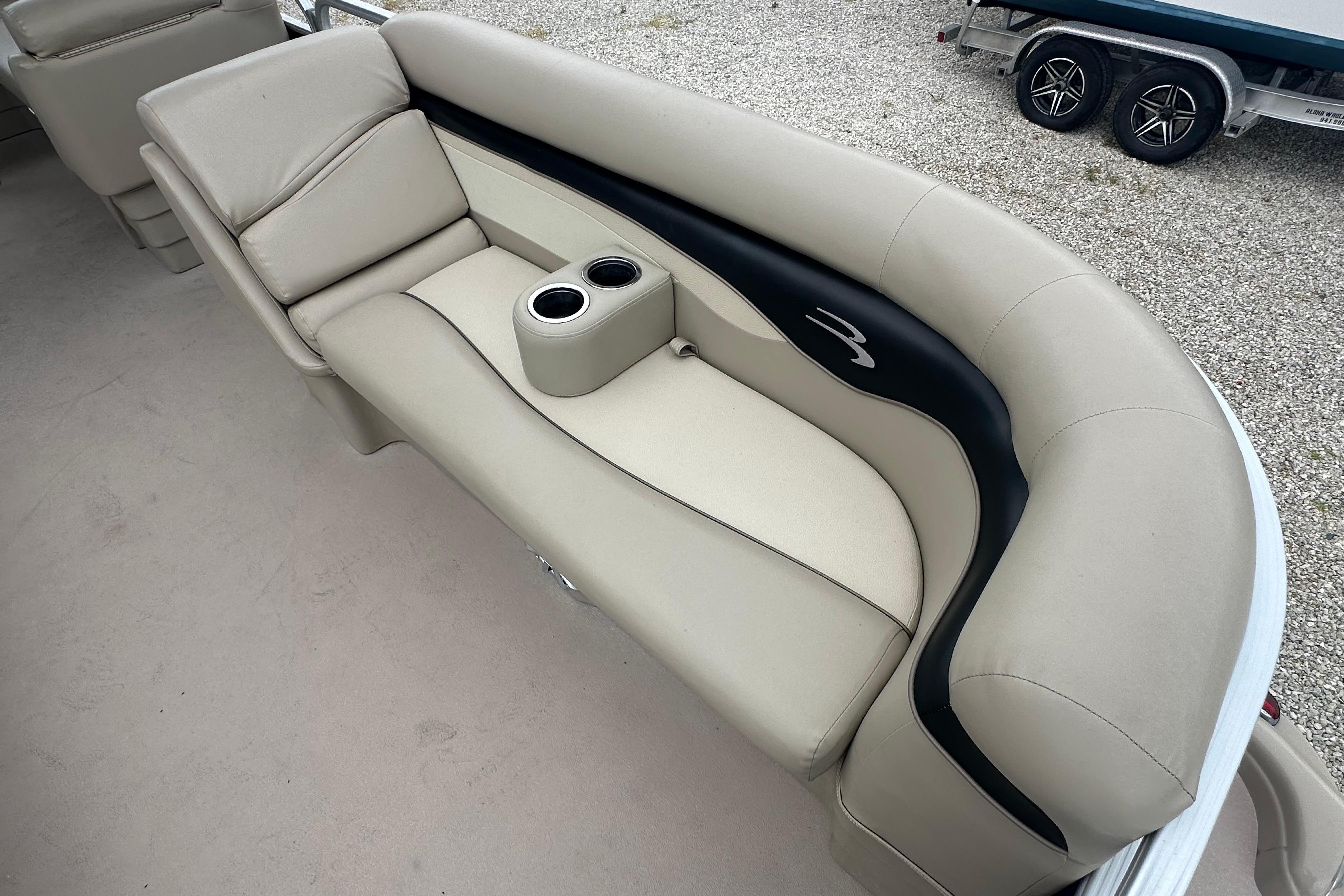 2014 Bennington S22 boat interior with beige seating and cup holders.