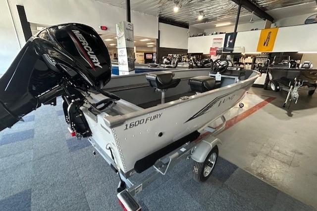 2027 Lund 1600 Fury SS boat with Mercury engine in showroom setting.