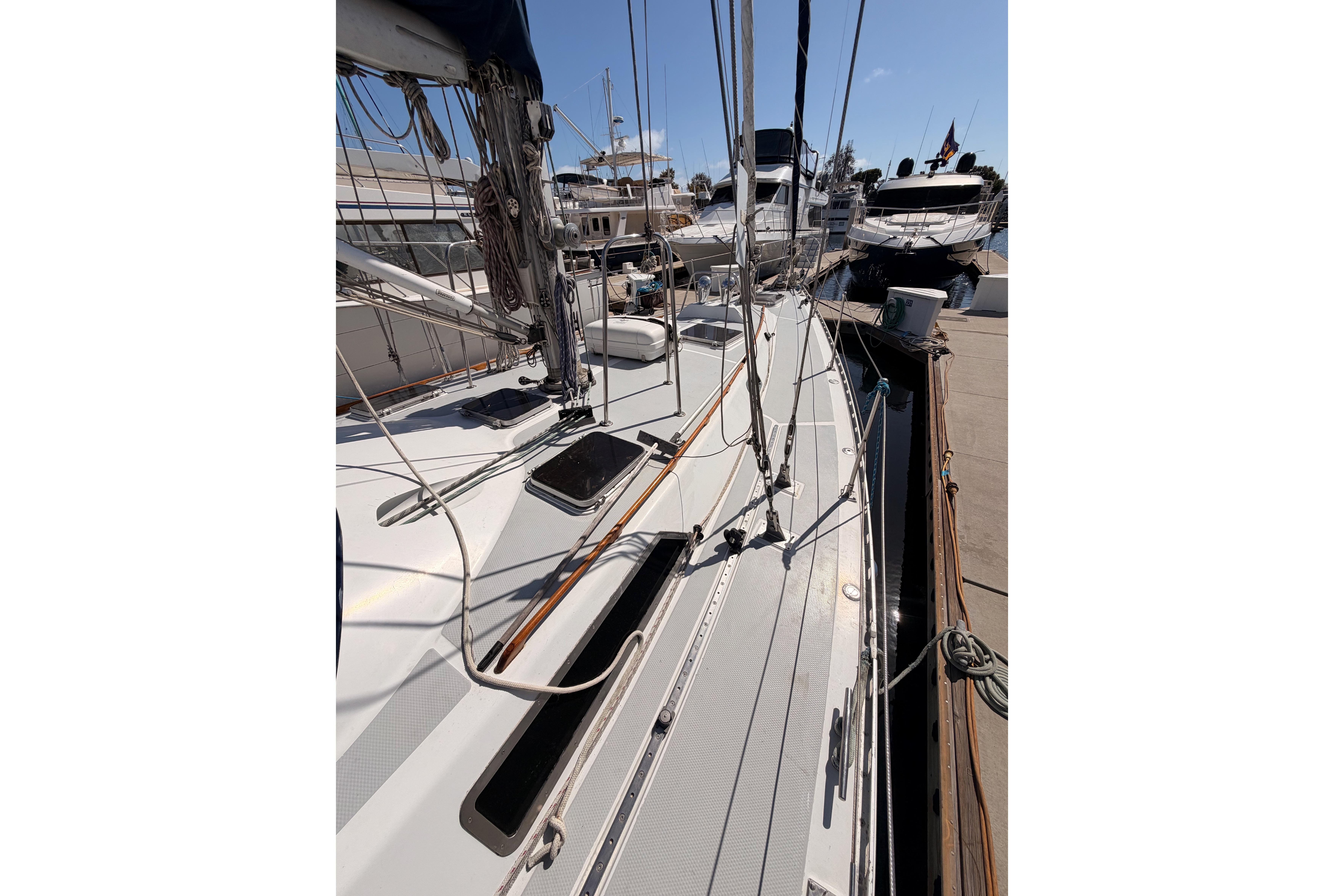 Sailboat docked at marina, Hylas 51 model, 1991, with visible rigging and deck details.