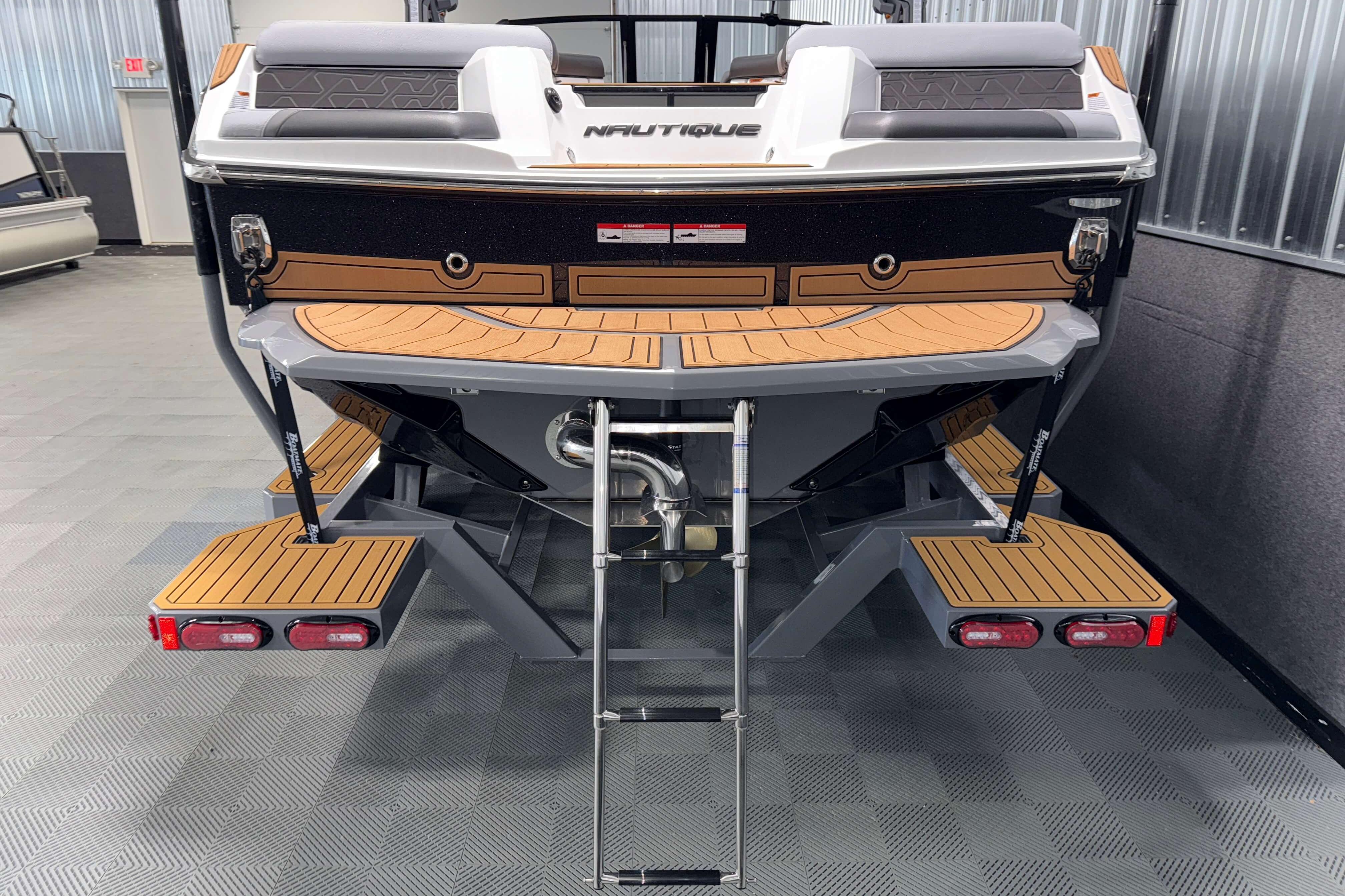 2026 Nautique Super Air Nautique GS22 boat rear view with swim platform and ladder.