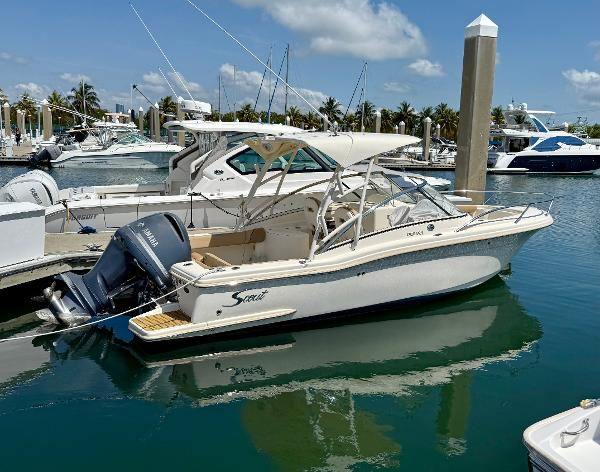 2016 Scout 245 Dorado boat docked in a marina under a clear blue sky.