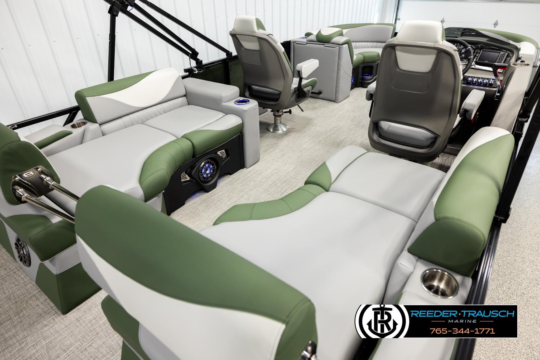 Luxurious interior of 2026 Avalon LSZ QLS pontoon boat with green and gray seating.