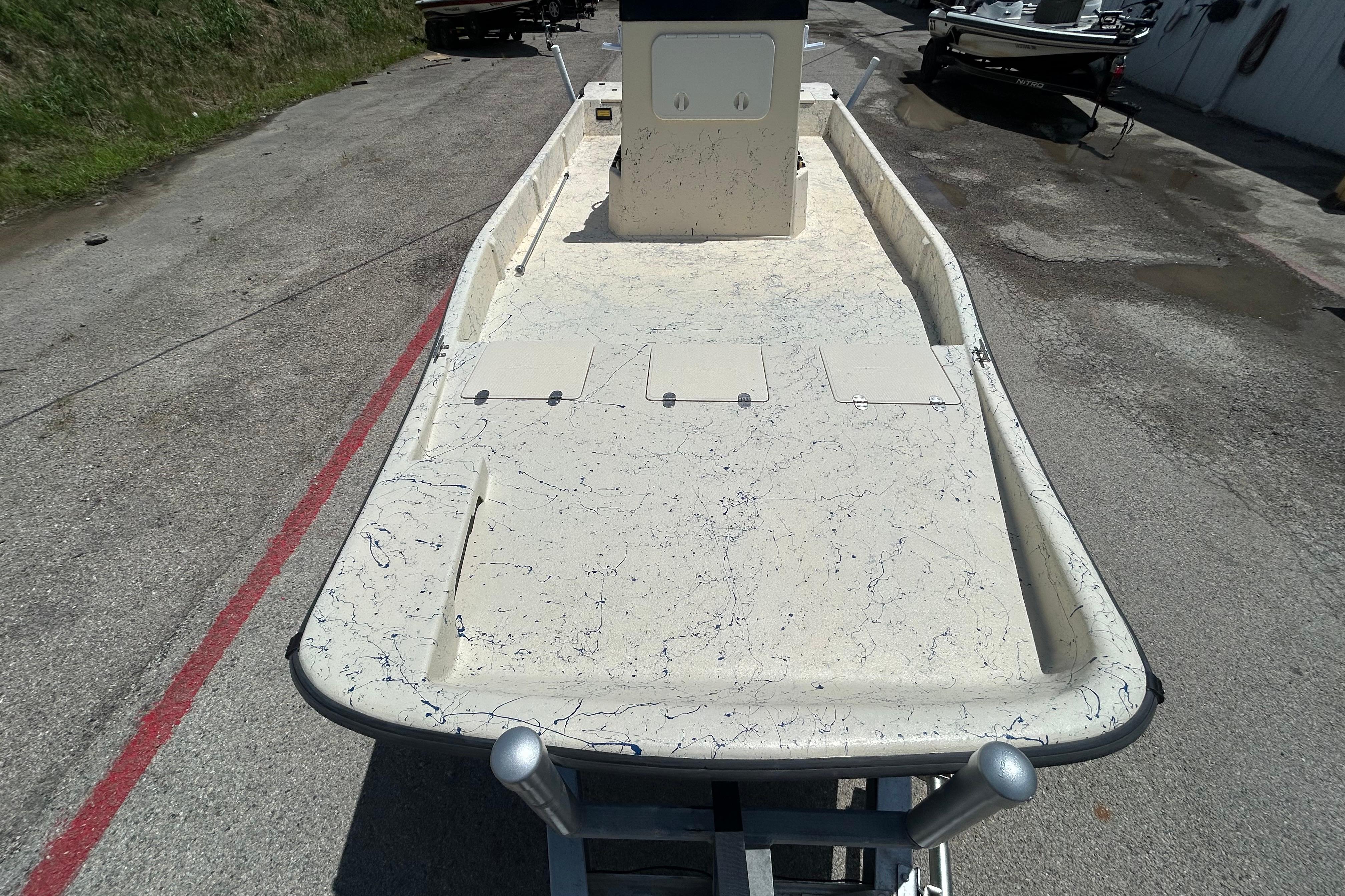 2007 Flats Cat 19 boat on trailer, showing spacious deck and storage compartments.