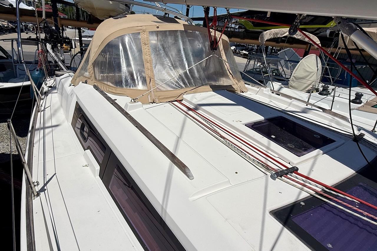 2016 Dufour 382 Grand Large sailboat deck with beige canopy and red ropes.