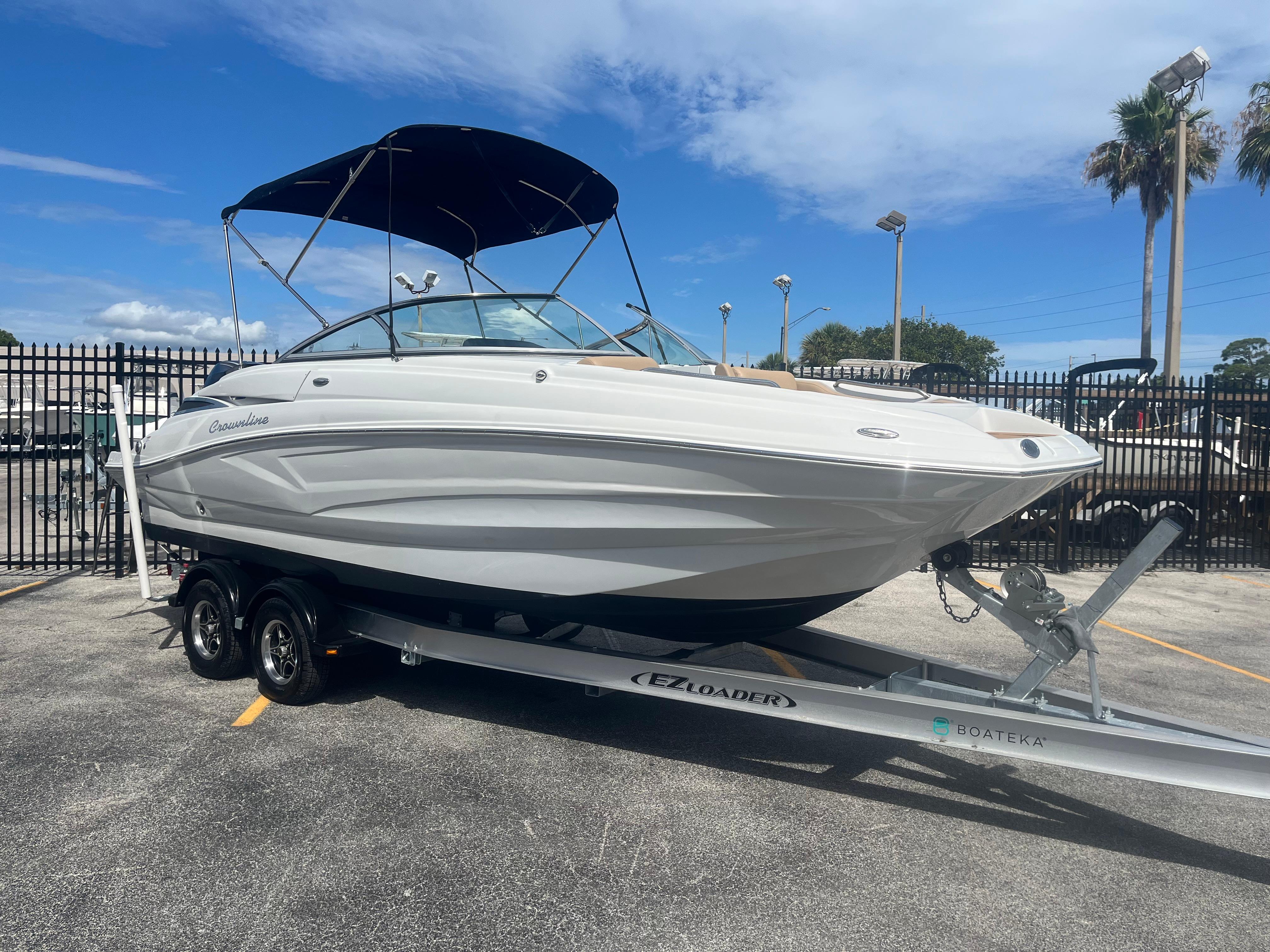 2022 Crownline Eclipse E235 XS boat on trailer, parked outdoors under blue sky.