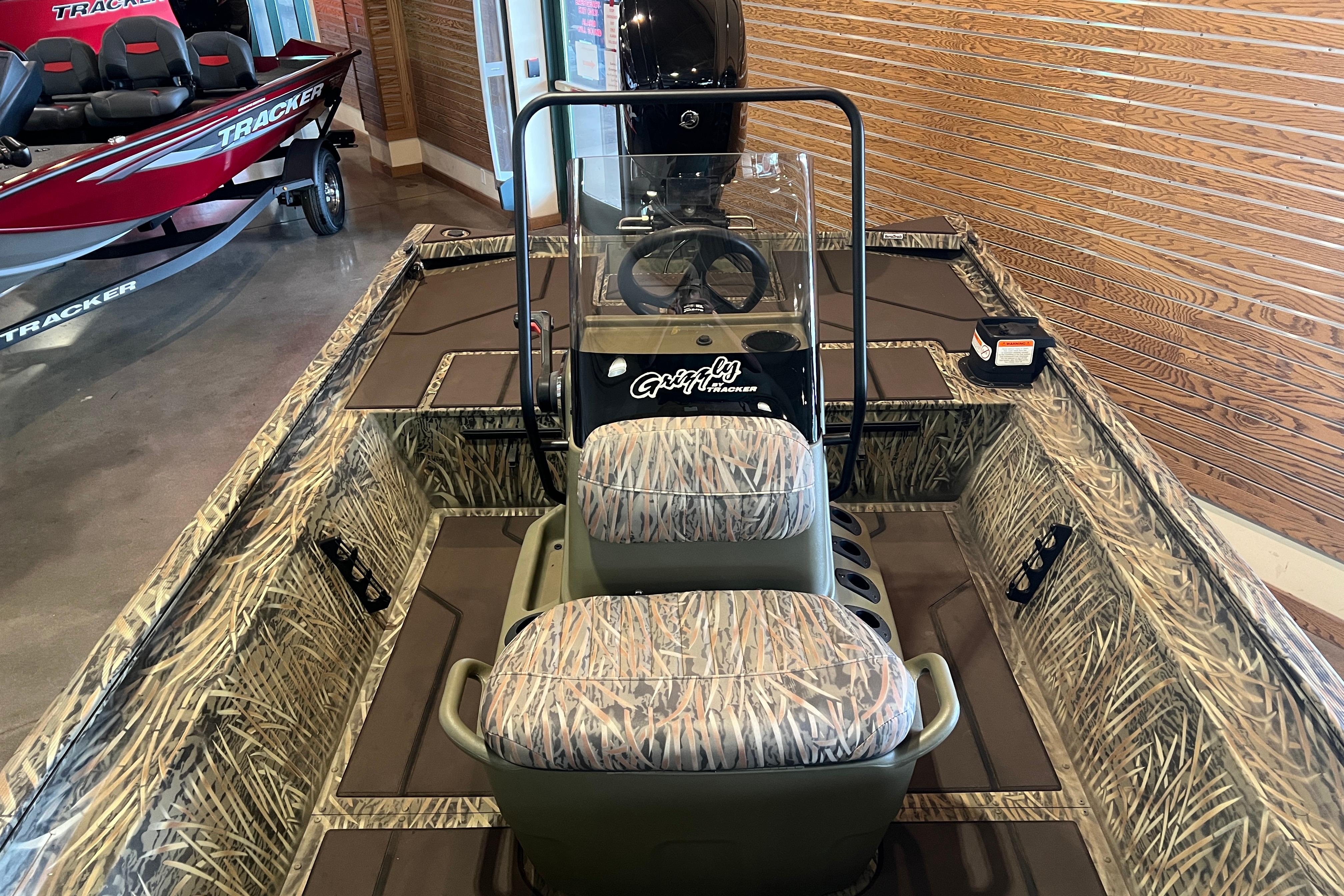 2026 Tracker Grizzly 1860 CC boat with camouflage interior and steering console.