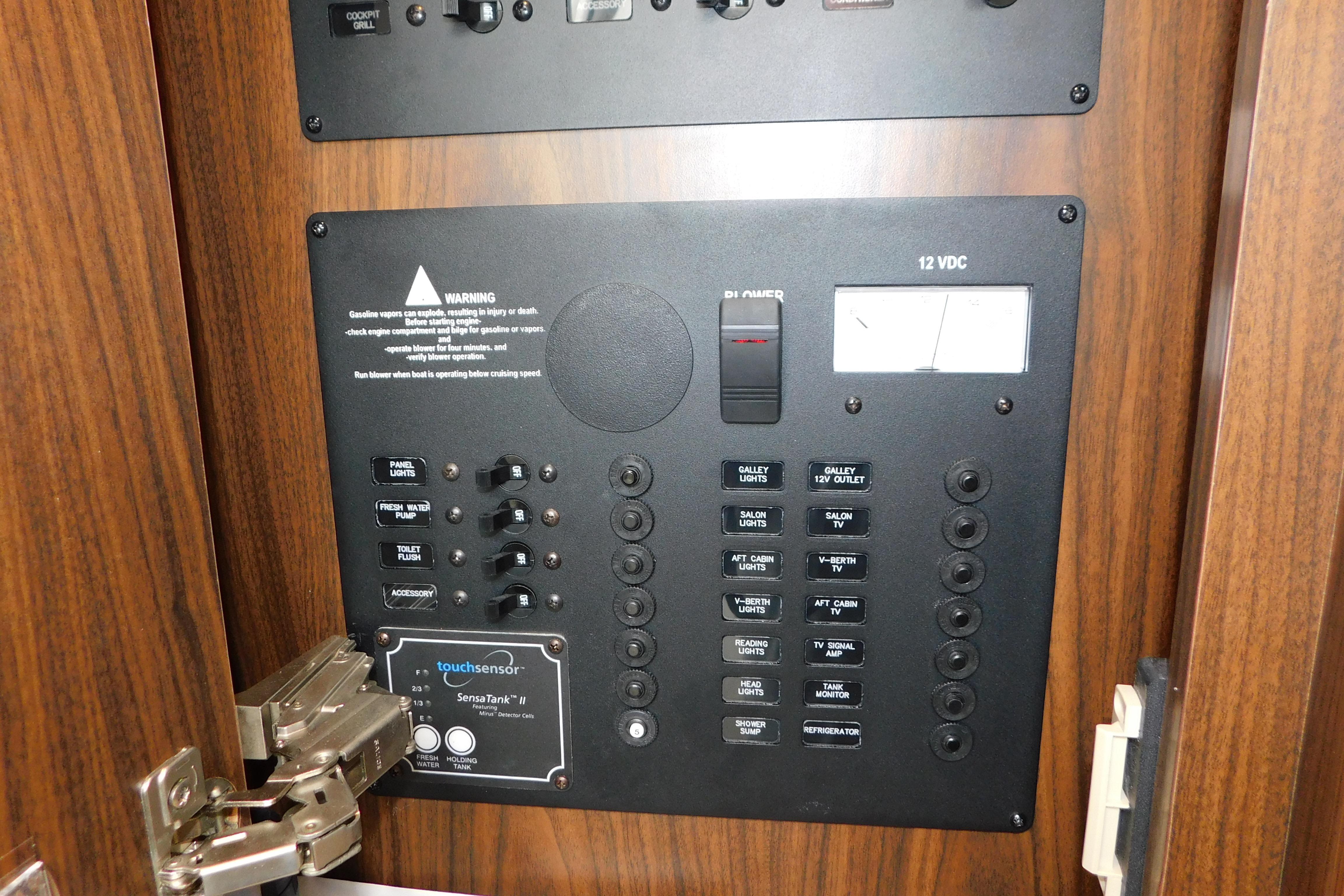 Control panel of a 2017 Rinker EX 320 boat with various switches and indicators.