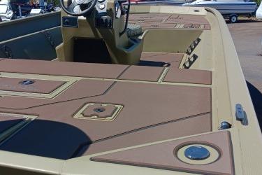 2026 Tracker Grizzly 2072 CC boat interior with steering console and storage compartments.