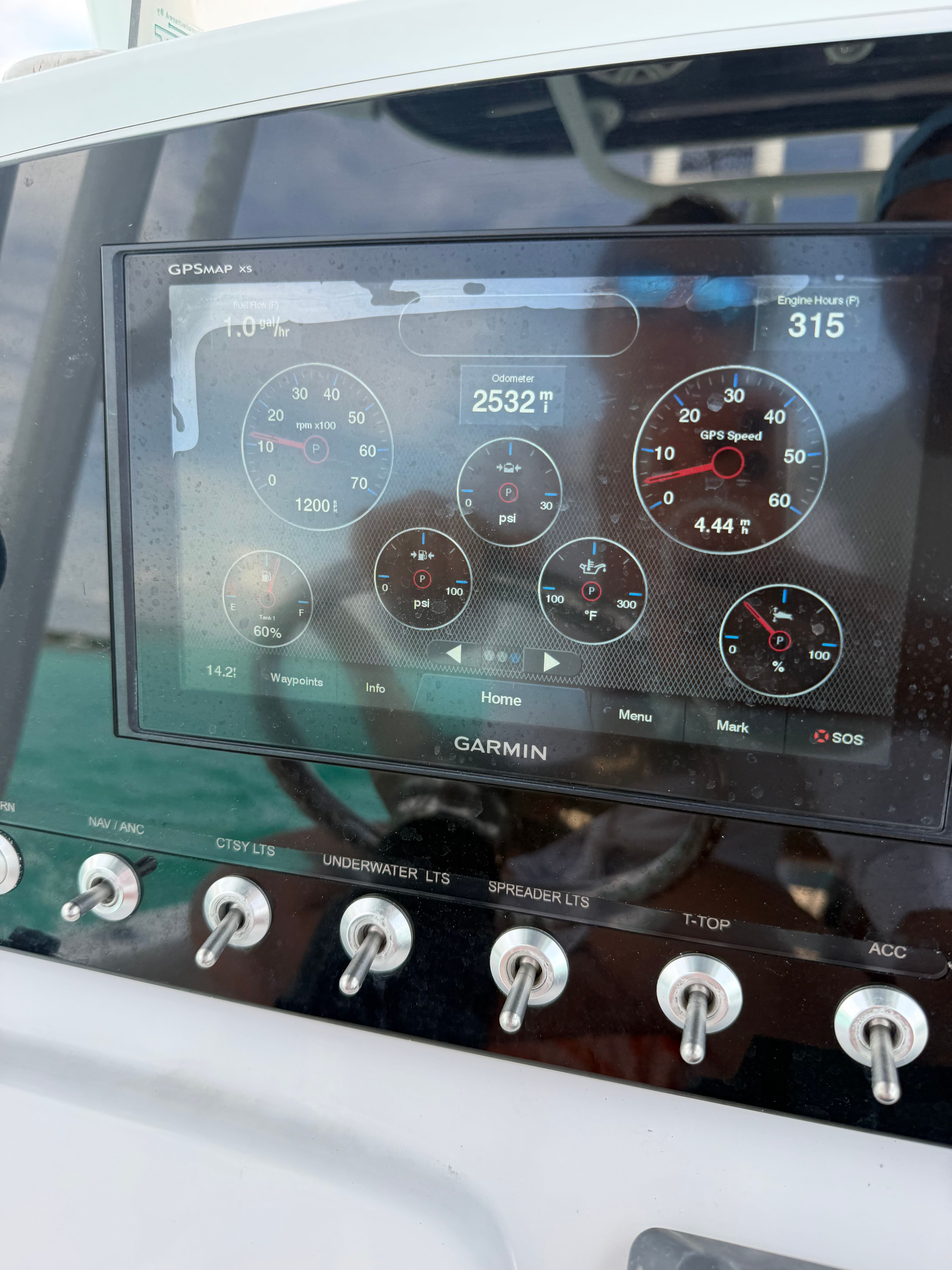 The image shows the dashboard of a Sportsman Heritage 211 Center Console boat with a Garmin display.
