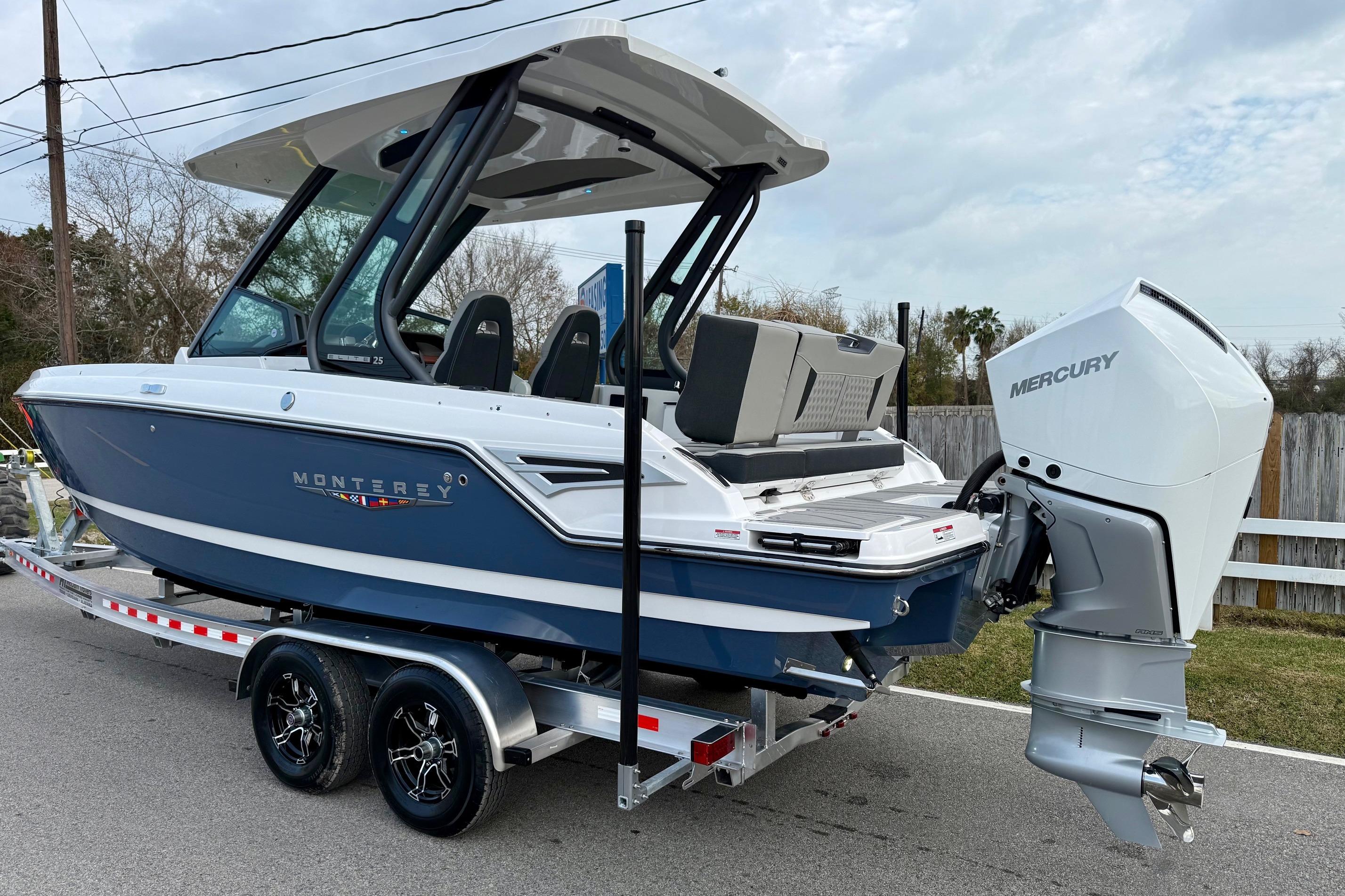 2026 Monterey Elite 25 OB boat on trailer with Mercury outboard engine.