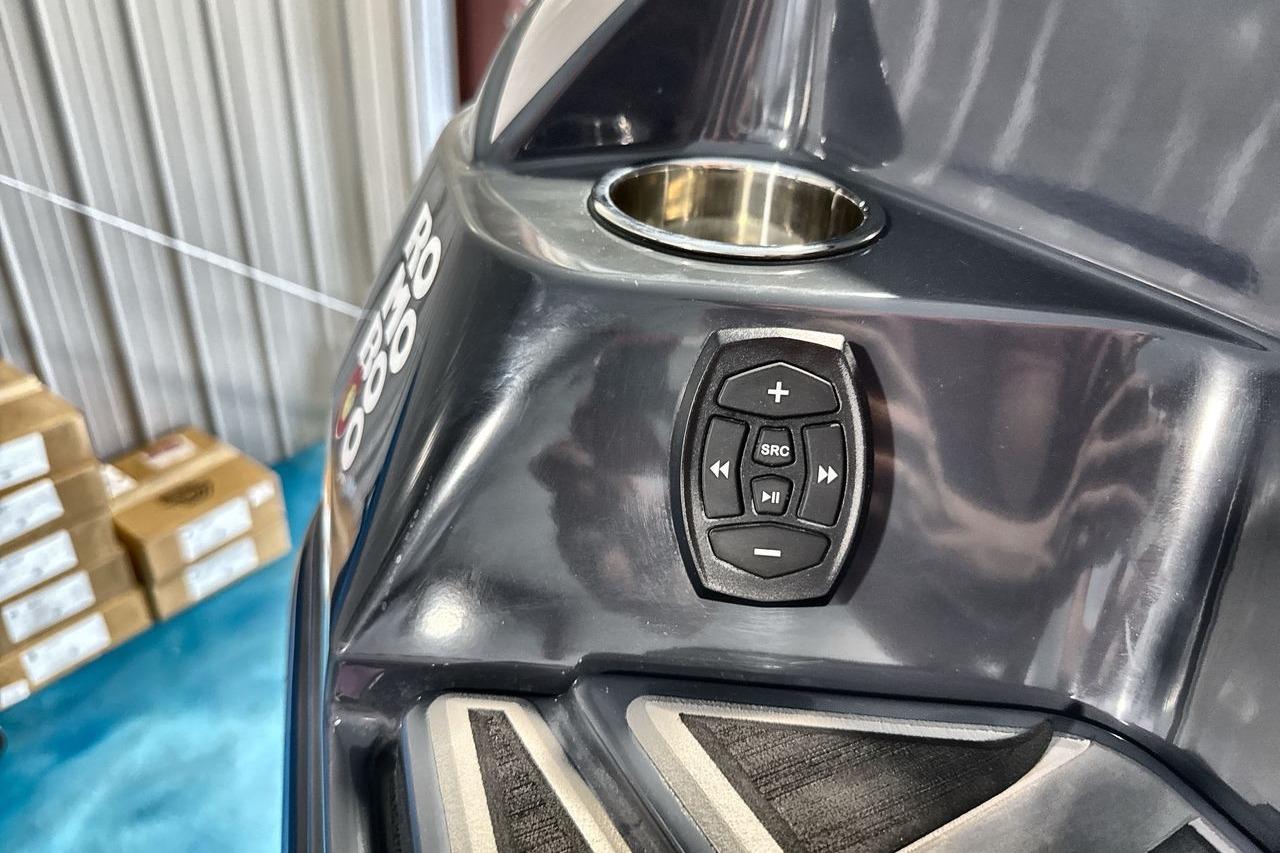 Control panel on 2021 Supra SE 550 boat, featuring audio controls and cup holder.