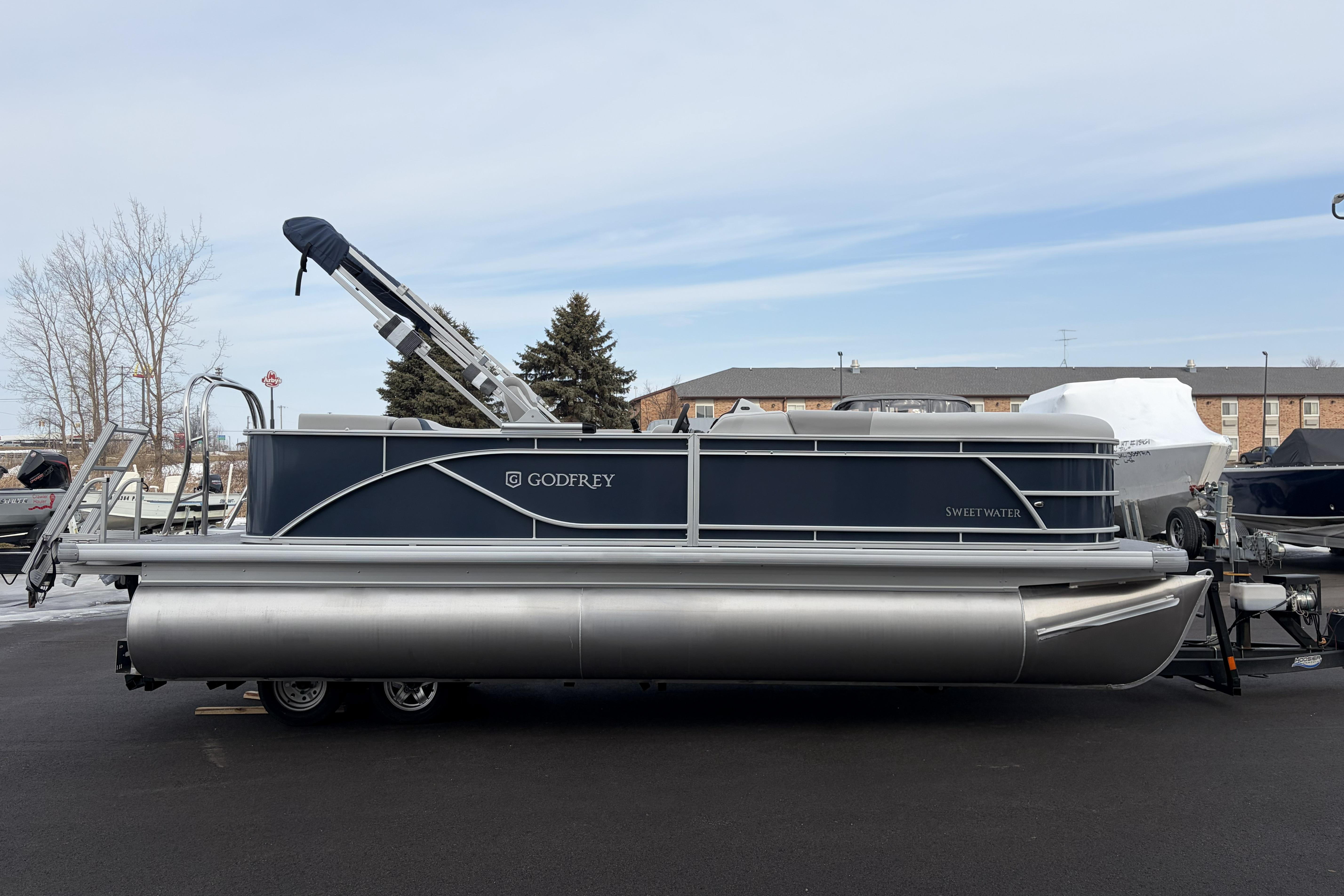 2026 Godfrey Sweetwater 2086 C pontoon boat on trailer, parked outdoors.