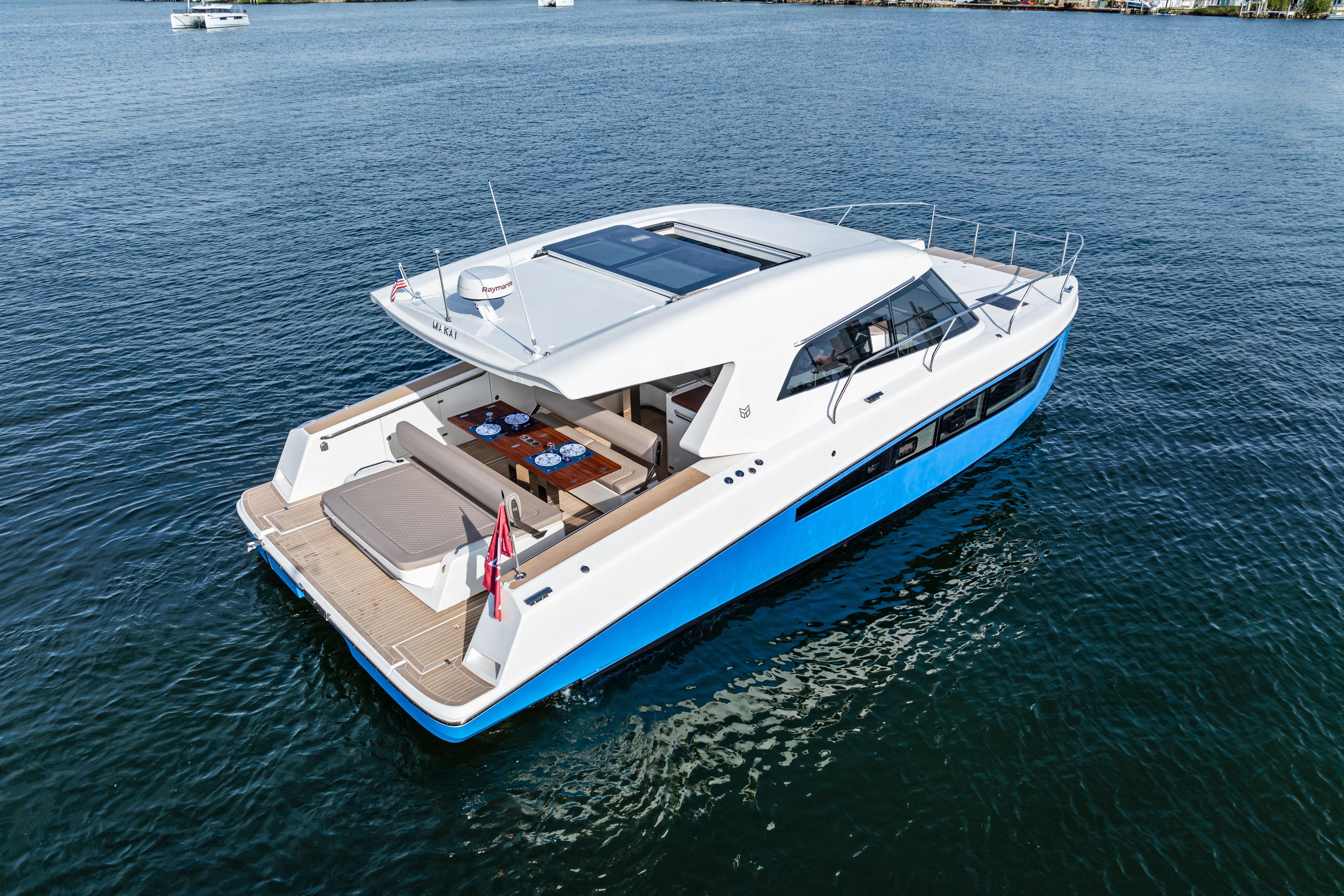 2025 Makai M37 yacht on calm water, featuring sleek design and spacious deck.