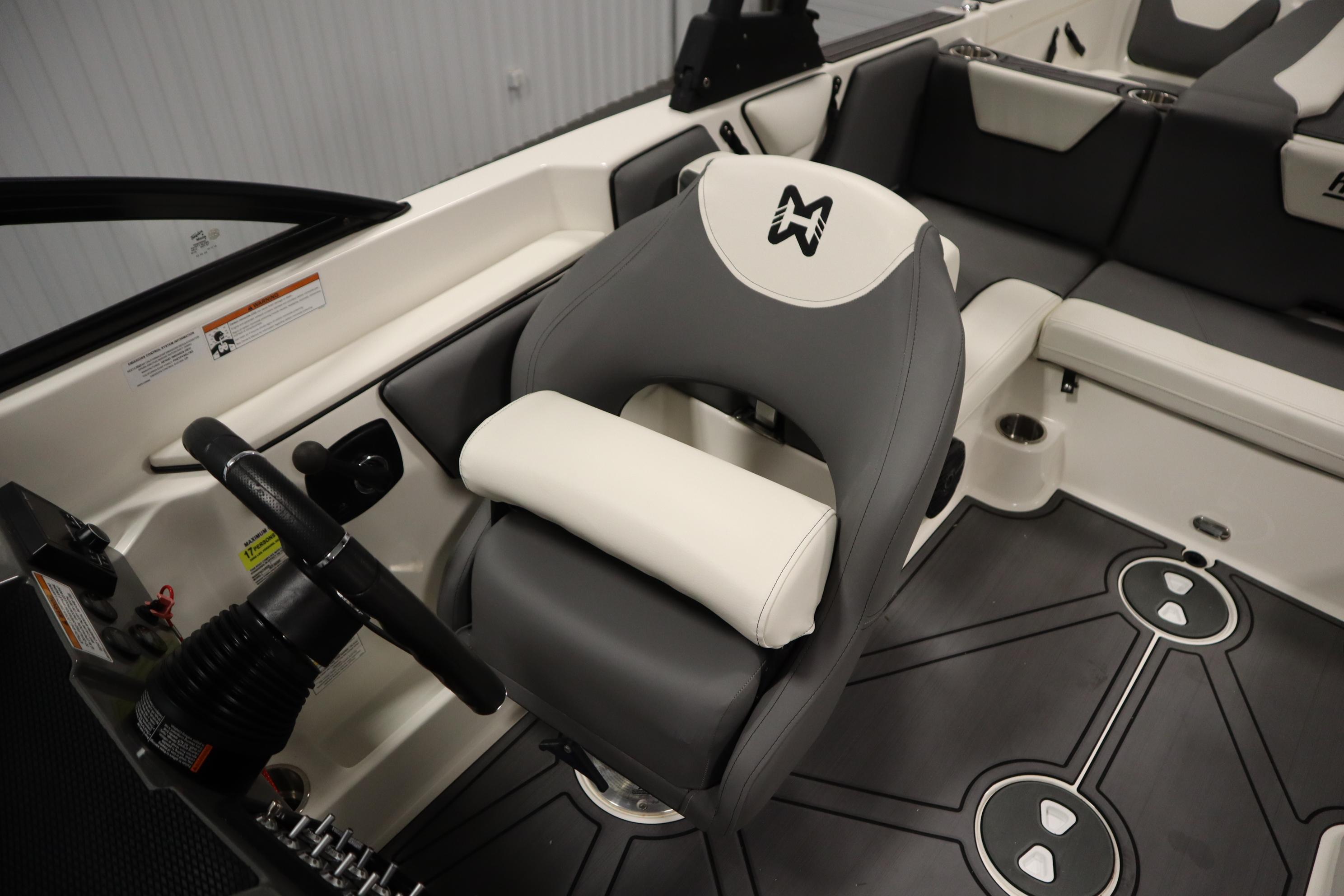 2023 Heyday WT Surf boat interior with steering wheel and cushioned seating.