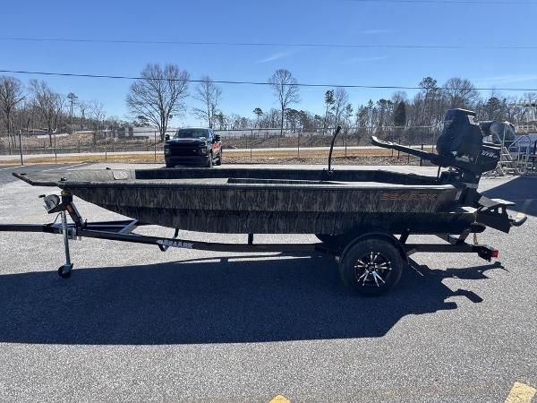 2025 SeaArk 1752 Slayer Pro boat on trailer, parked outdoors.