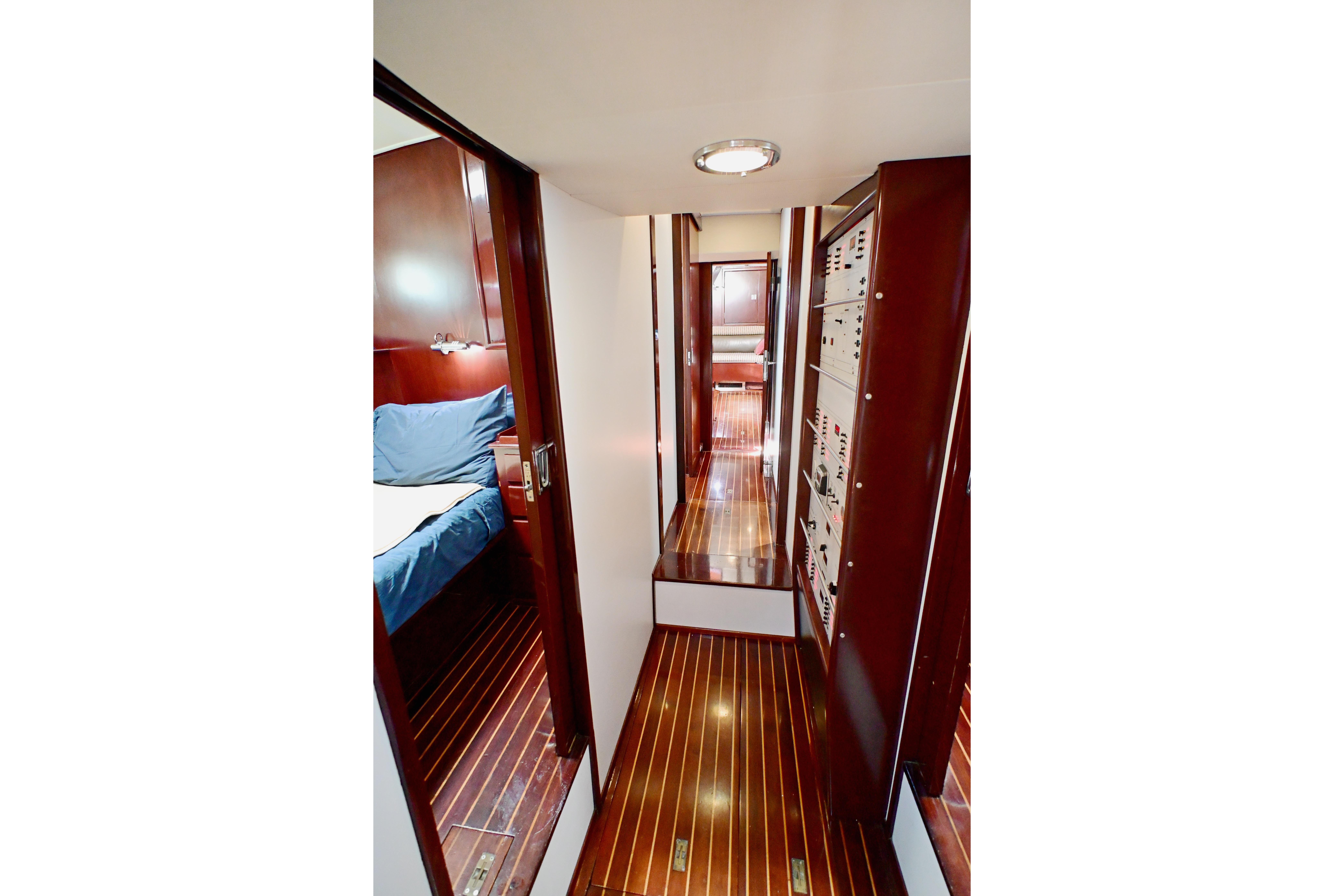 Luxurious wooden interior of 1968 Abeking & Rasmussen Tripp 74 yacht, featuring cozy cabin and hallway.