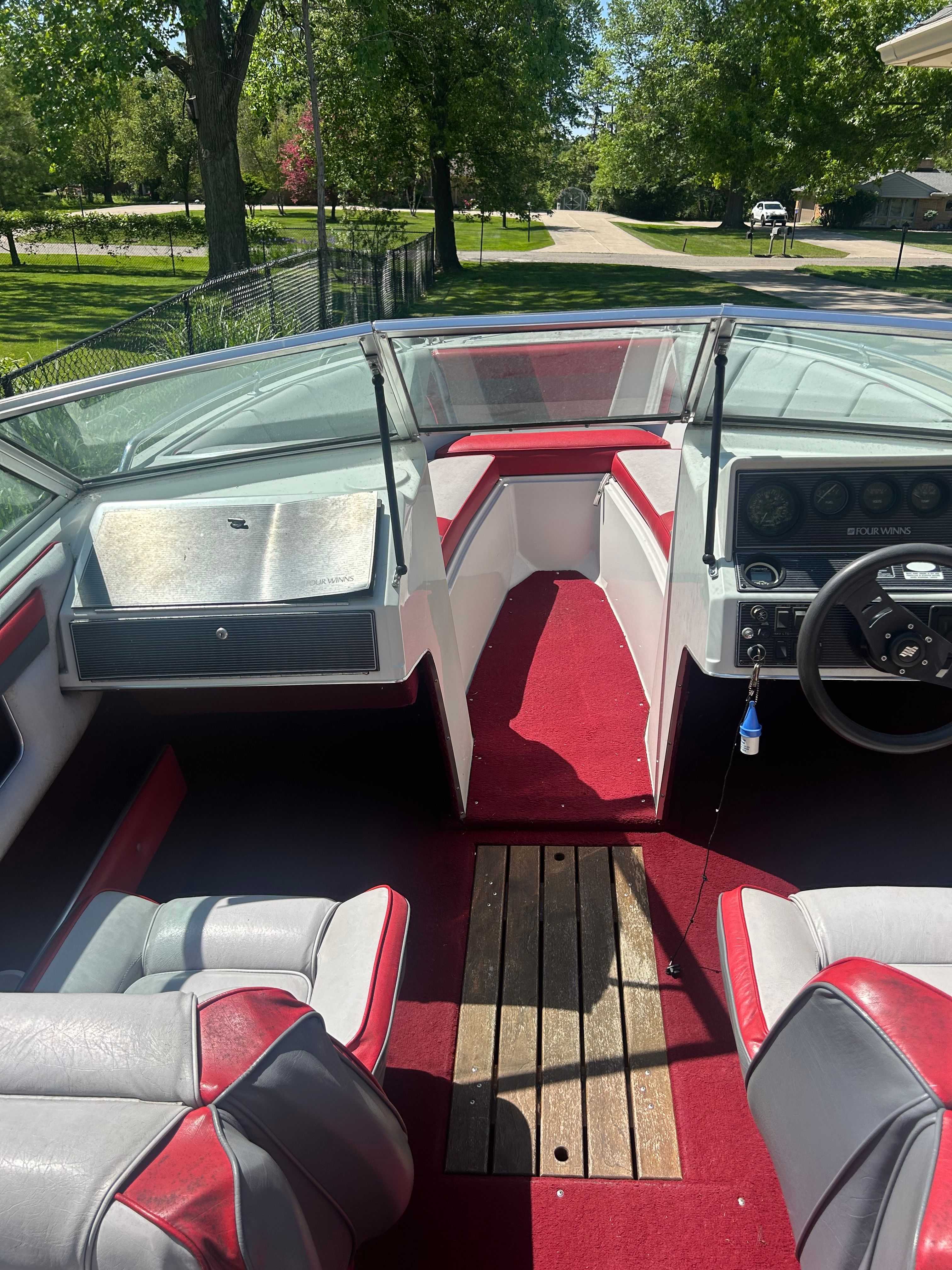 Interior of a 1989 Four Winns Horizon boat with red carpet.