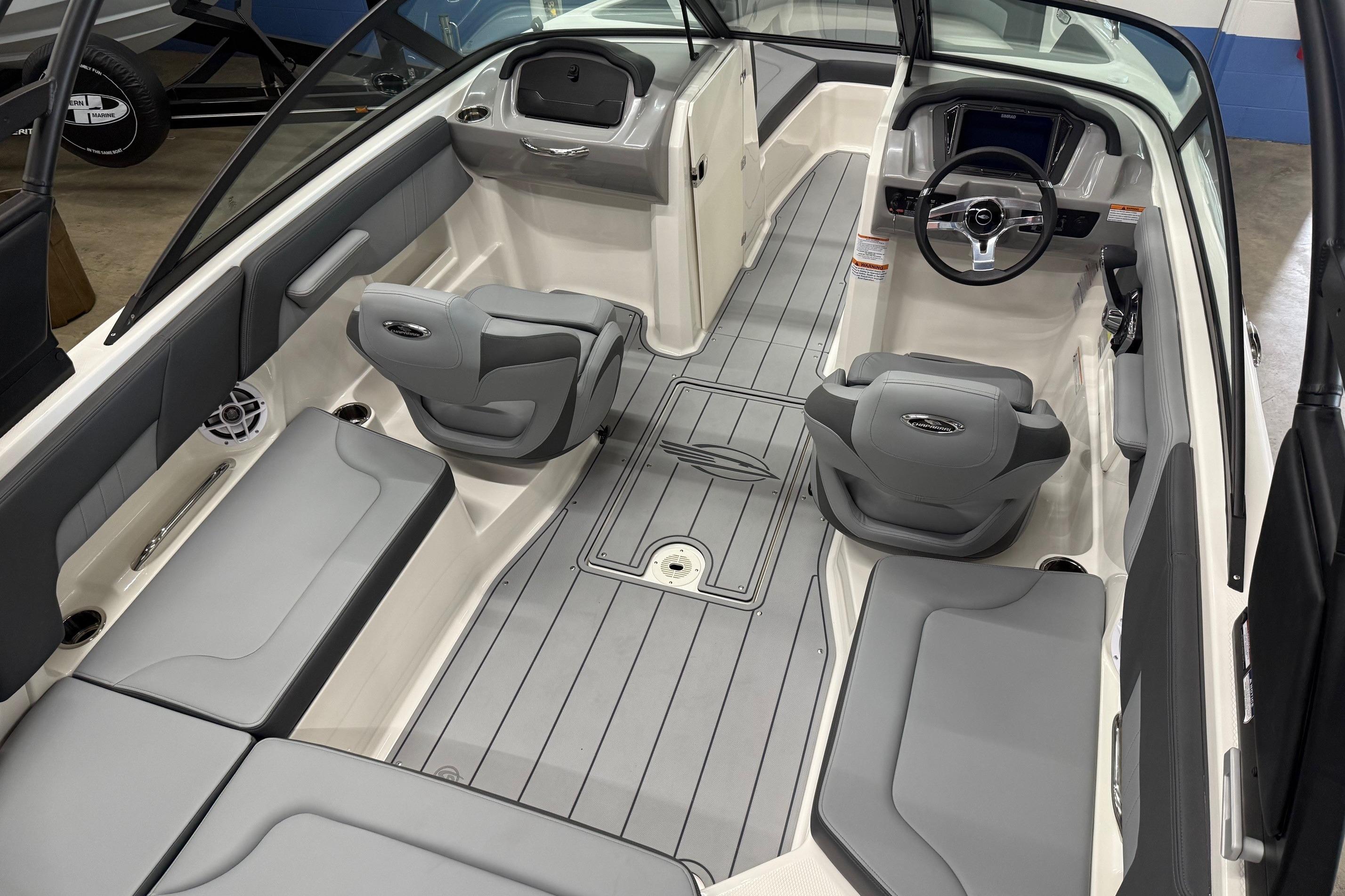 2026 Chaparral 23 SSi boat interior with gray seating and modern dashboard design.