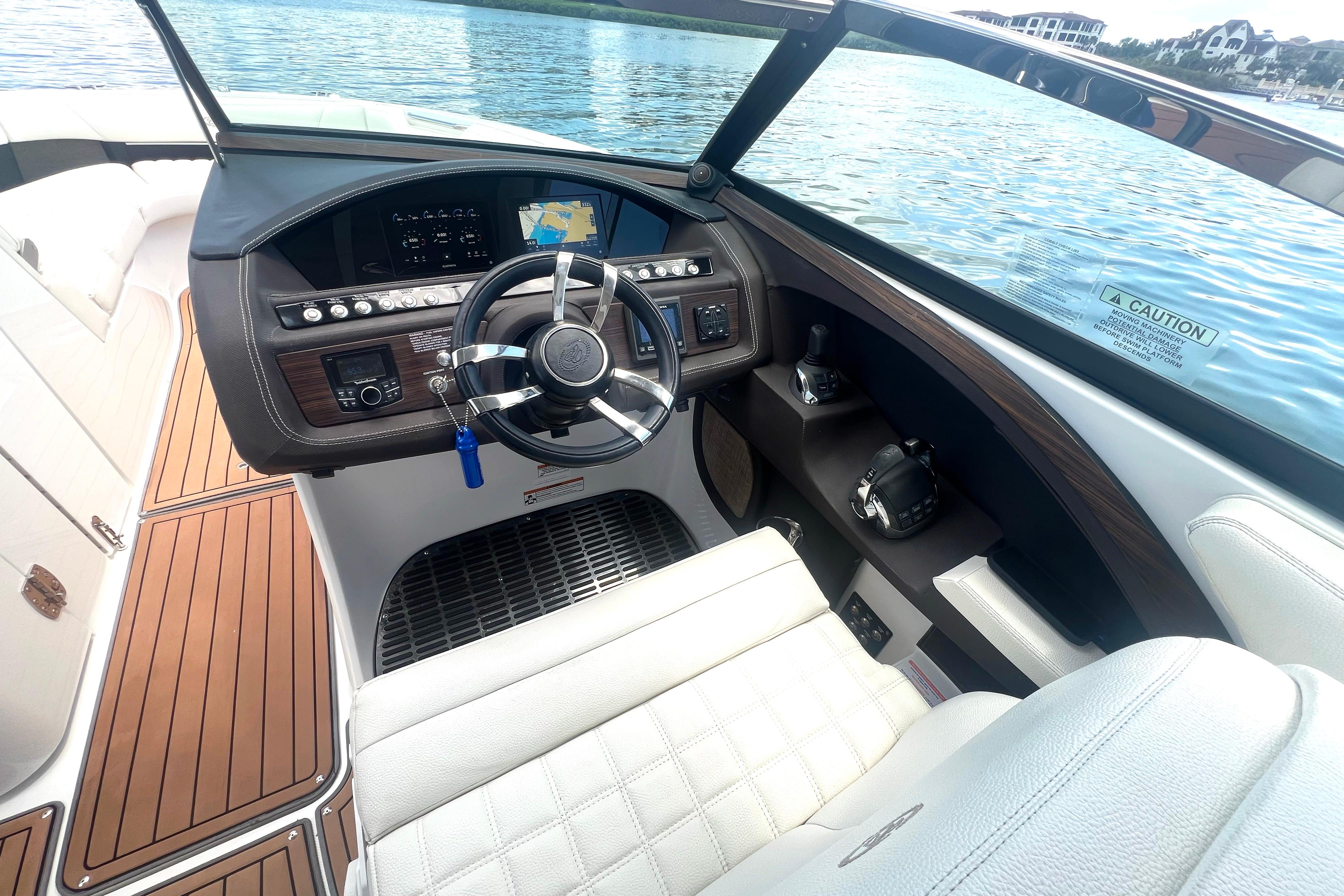 Cockpit of 2017 Cobalt R30 boat with steering wheel and navigation display.