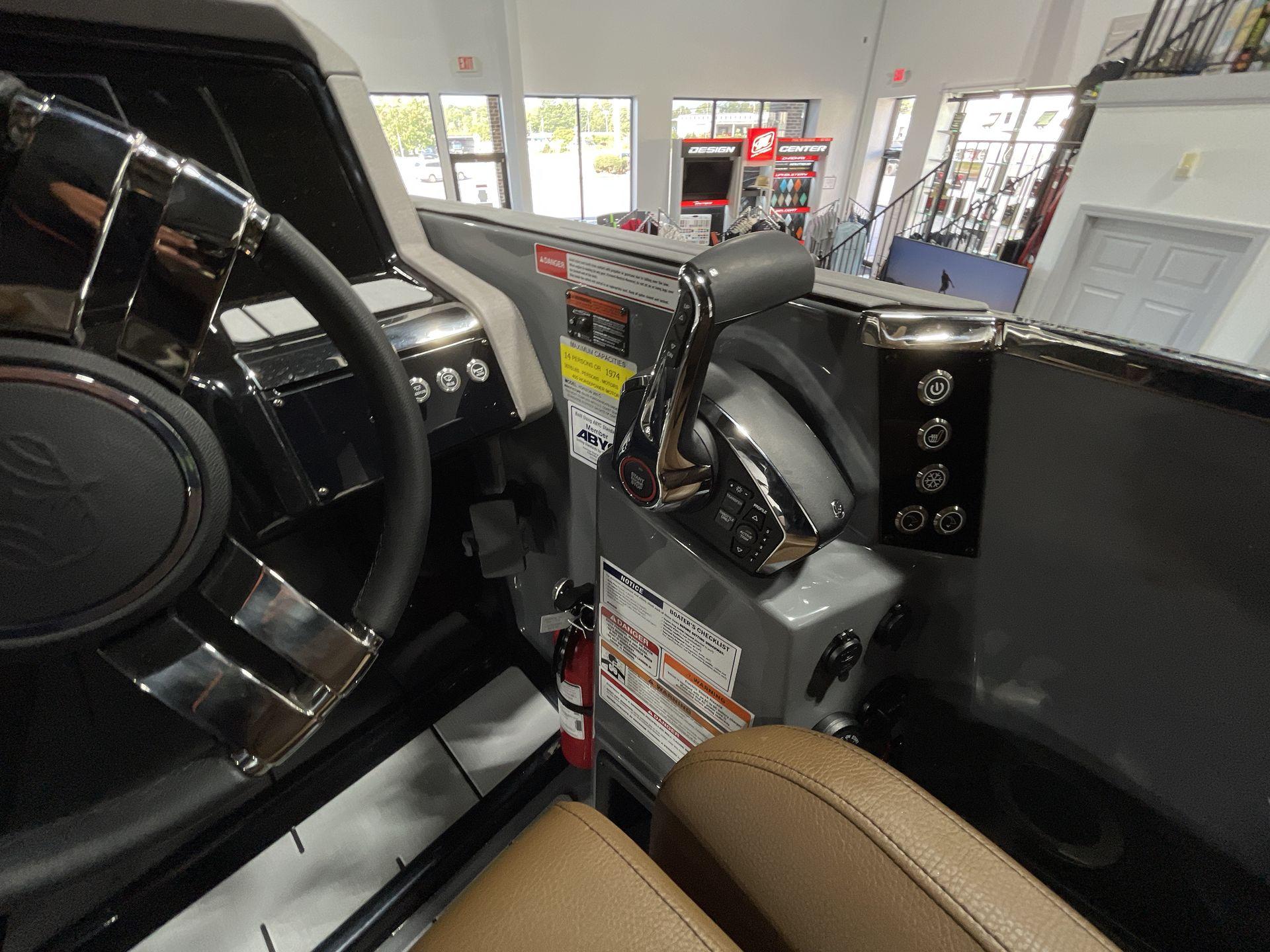Interior of 2025 Balise Horizon 26C boat, featuring steering wheel and control panel.